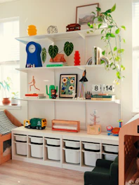 Shelves filled with books, plants, and decorative items.