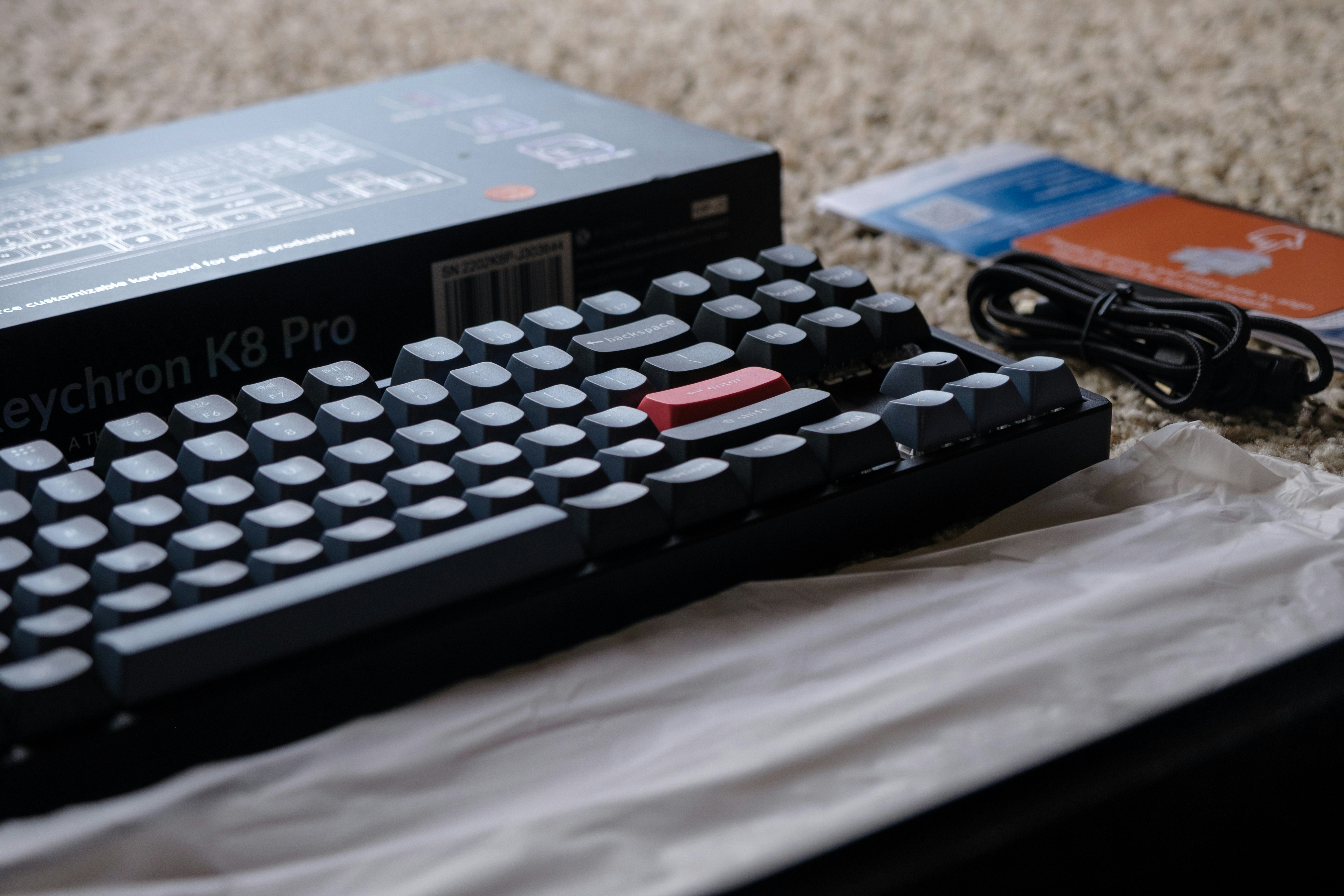 Mechanical keyboard with red key and charging cable
