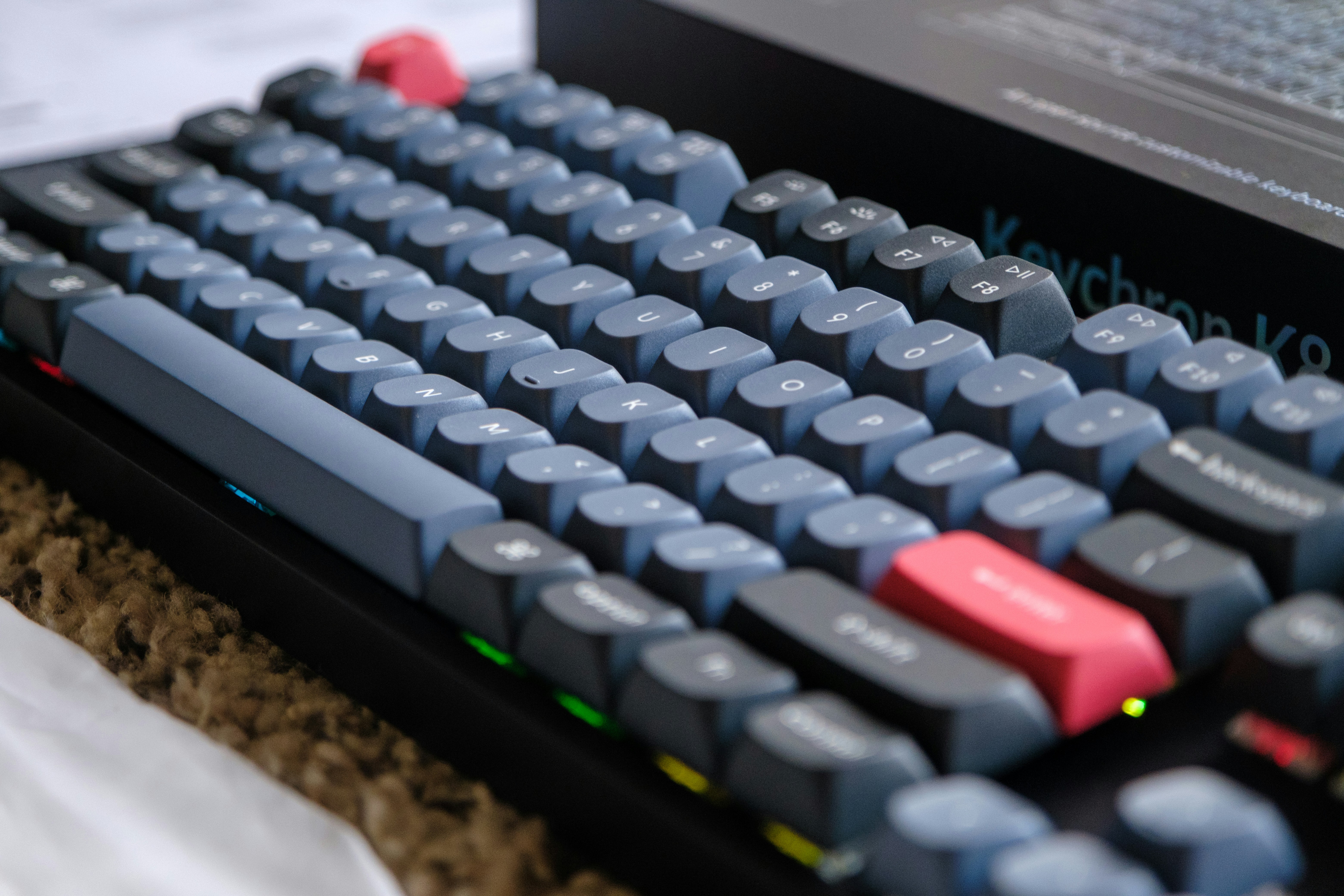 Close-up of a mechanical keyboard with gray and red keys