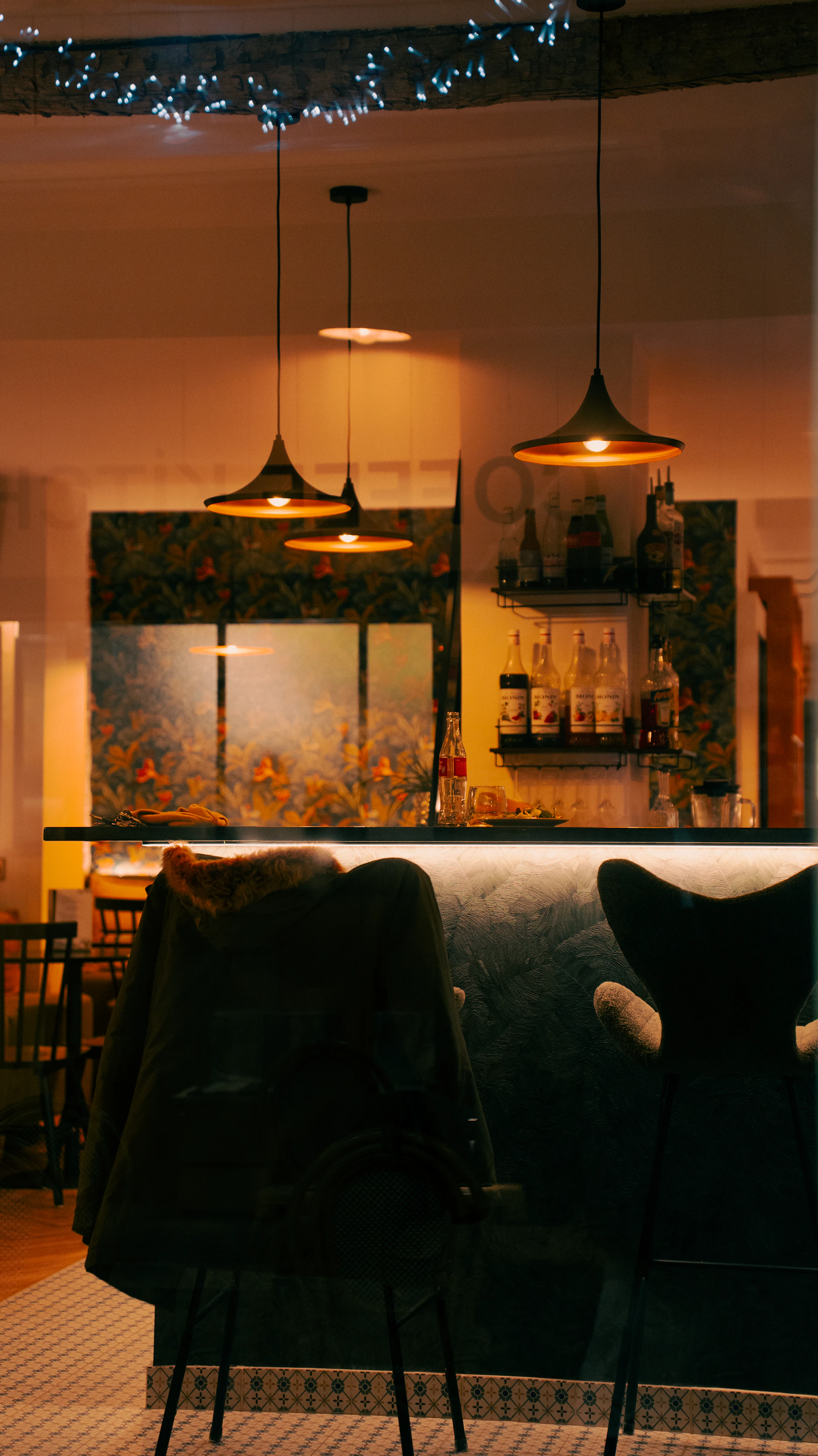 Bar interior with pendant lights and chairs