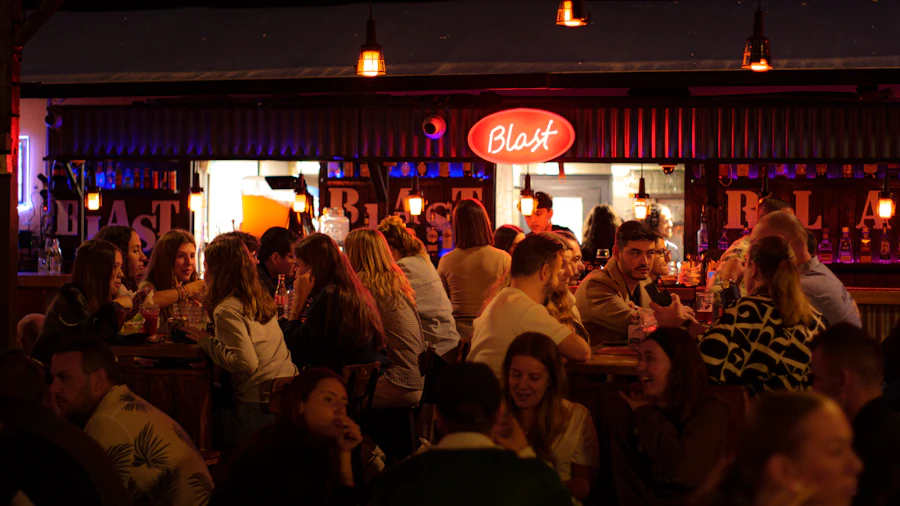 A packed, buzzing bar at night — merch and tabs settled in a single tap
