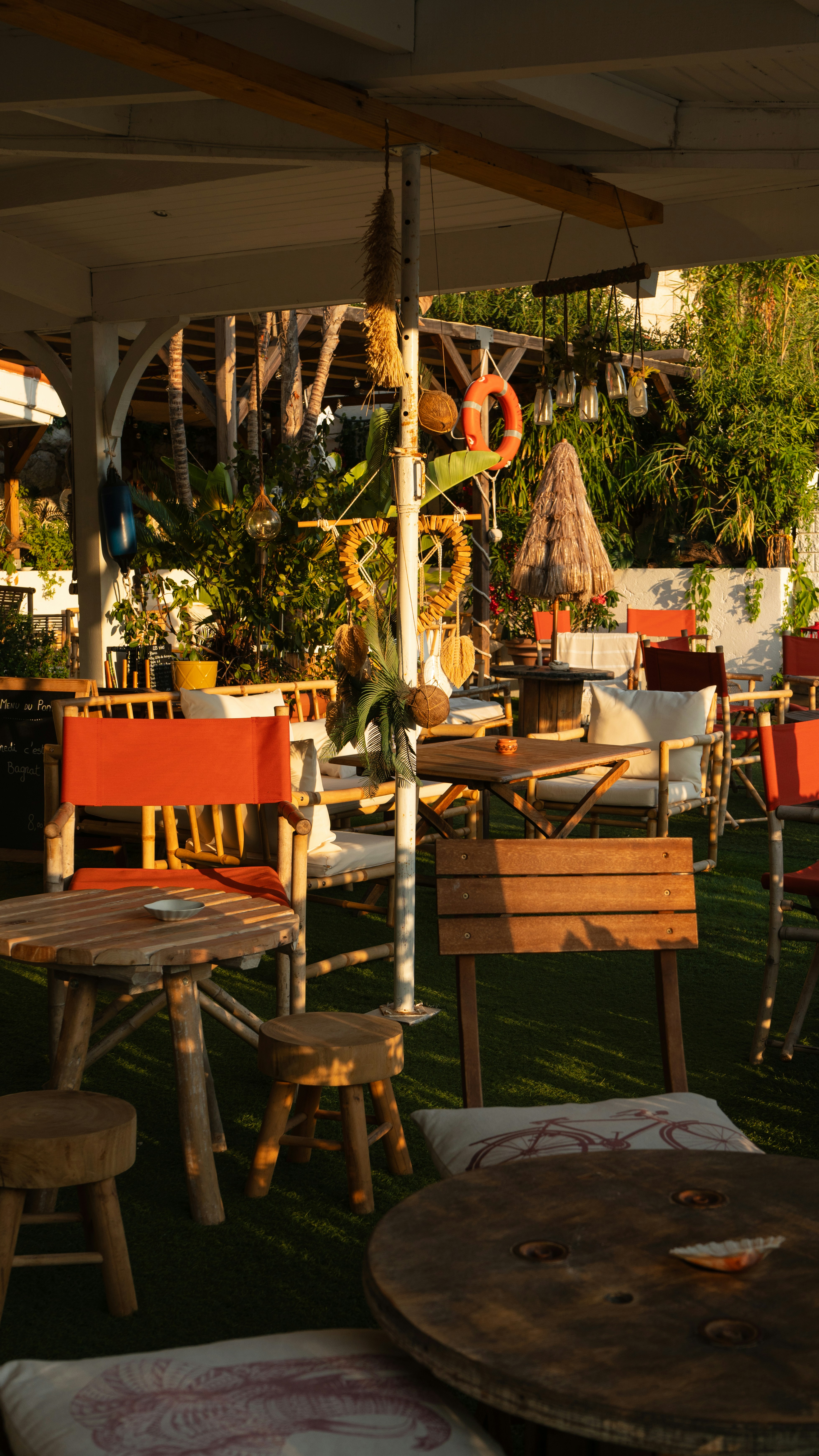 Outdoor cafe seating area with tables and chairs.