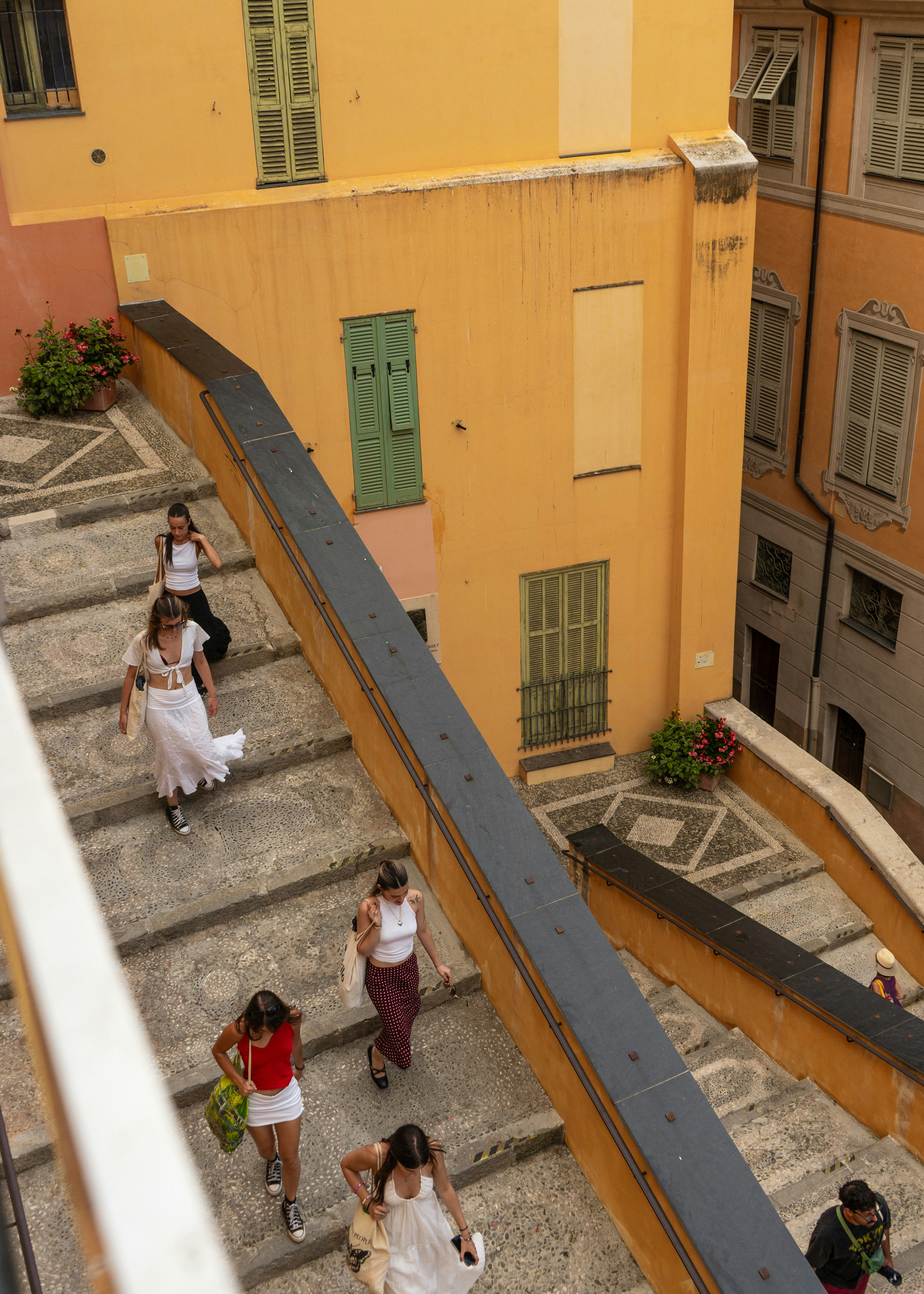 People walking up a colorful outdoor staircase
