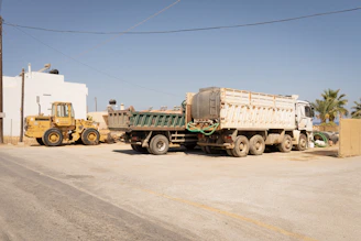 Yellow loader and trucks at a construction site