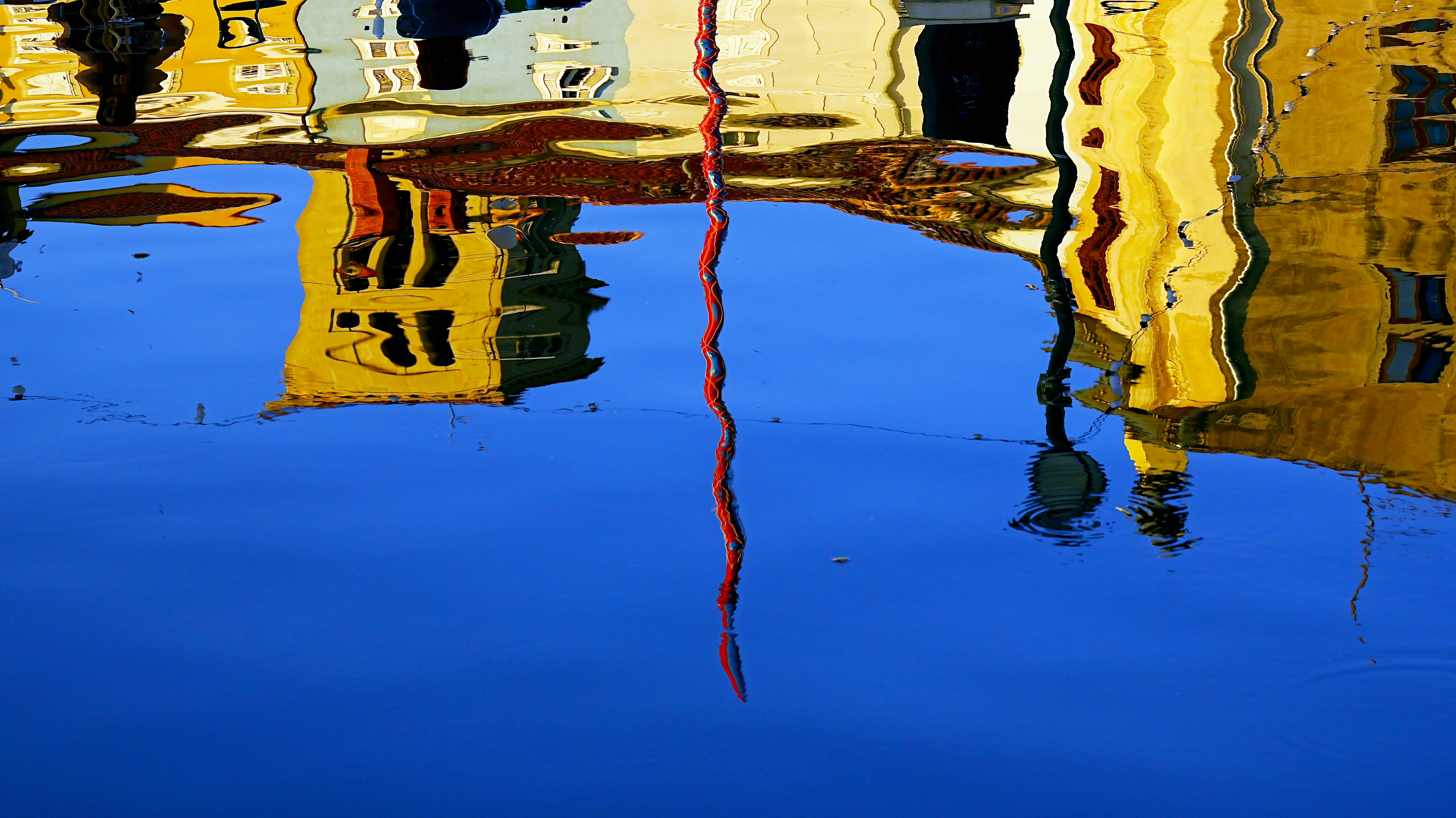 Colorful buildings reflected in blue water