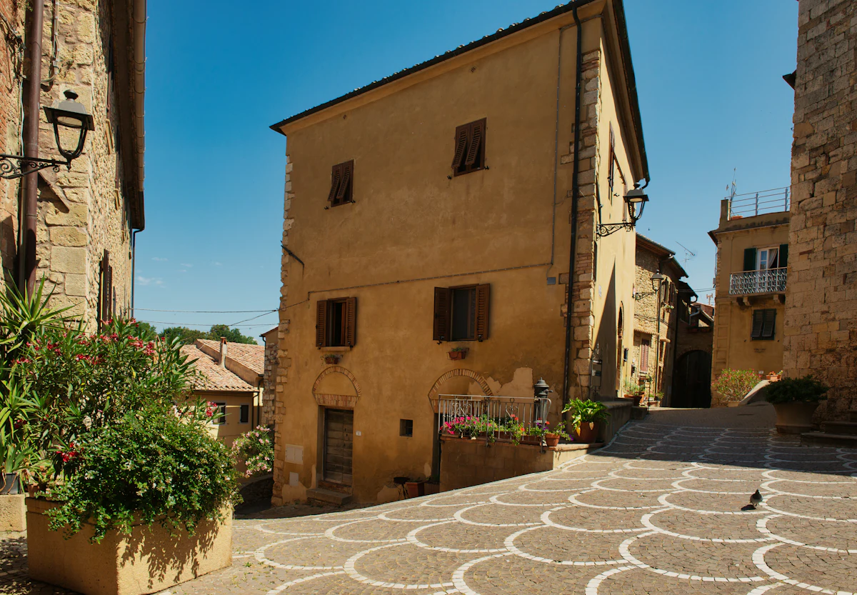 Old European town square lined with historic buildings and cobblestone pavement