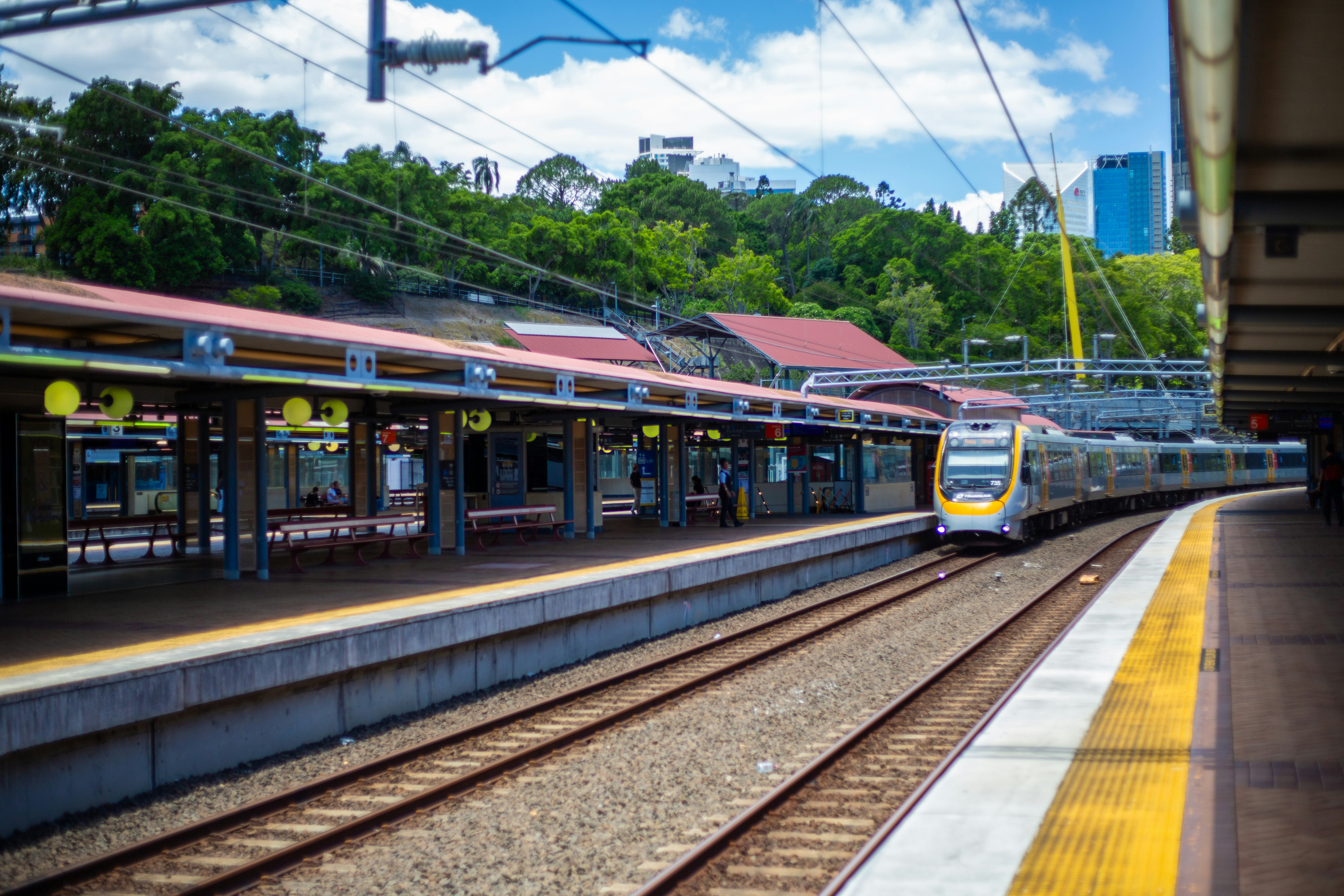 A modern train arriving at a station platform.