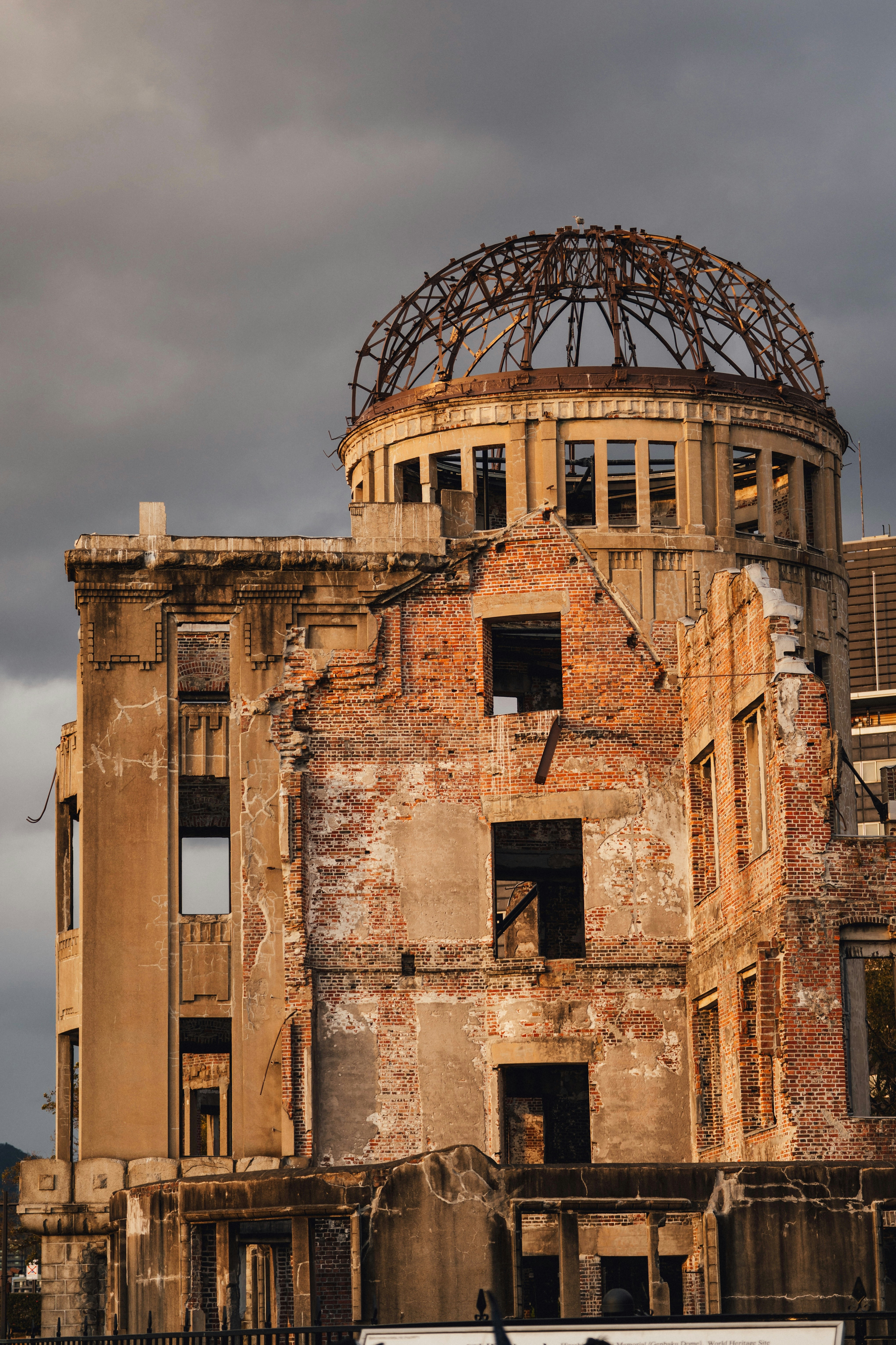 Ruined building with damaged dome under cloudy sky
