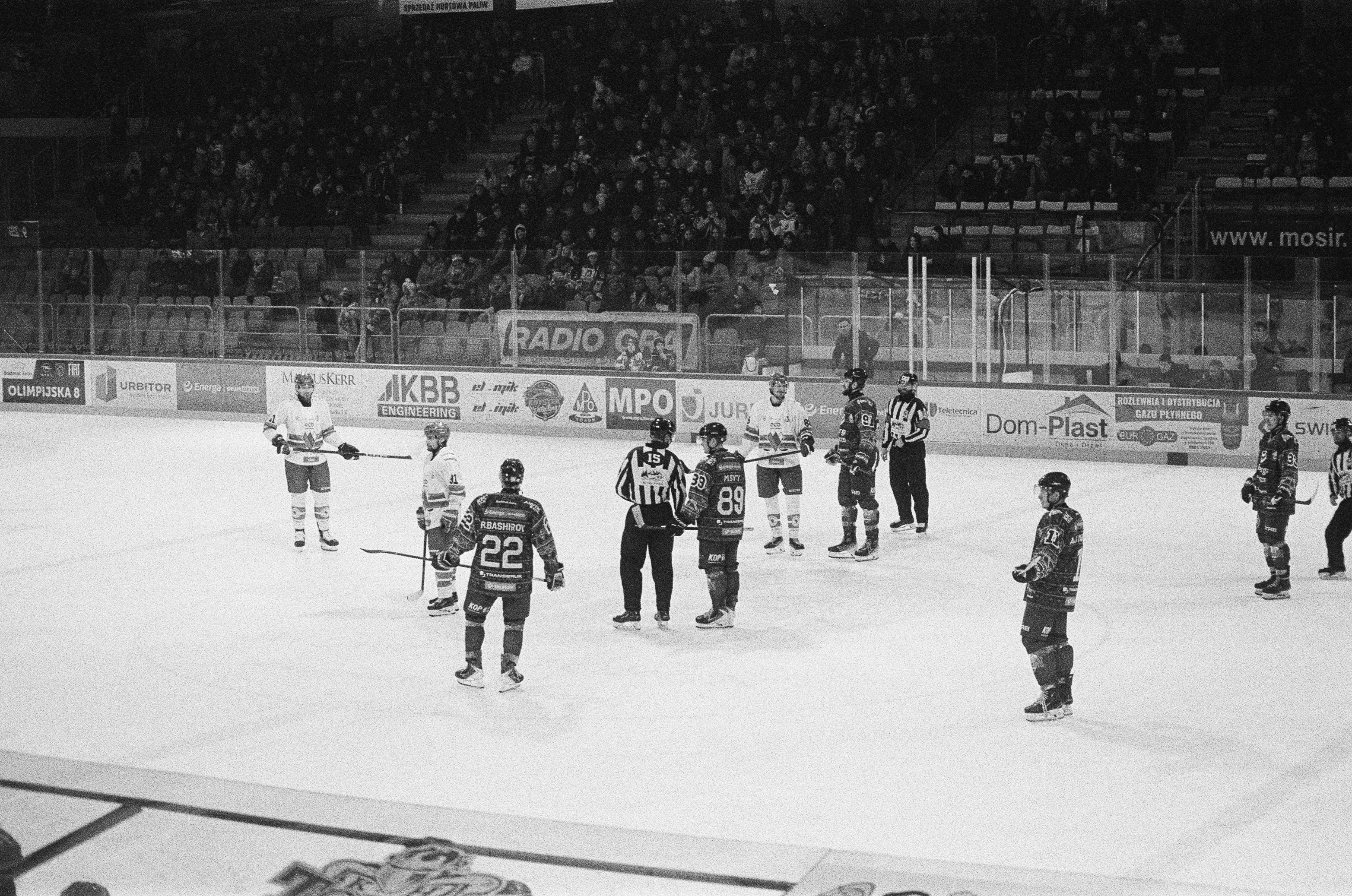 Hockey players and referees on ice rink