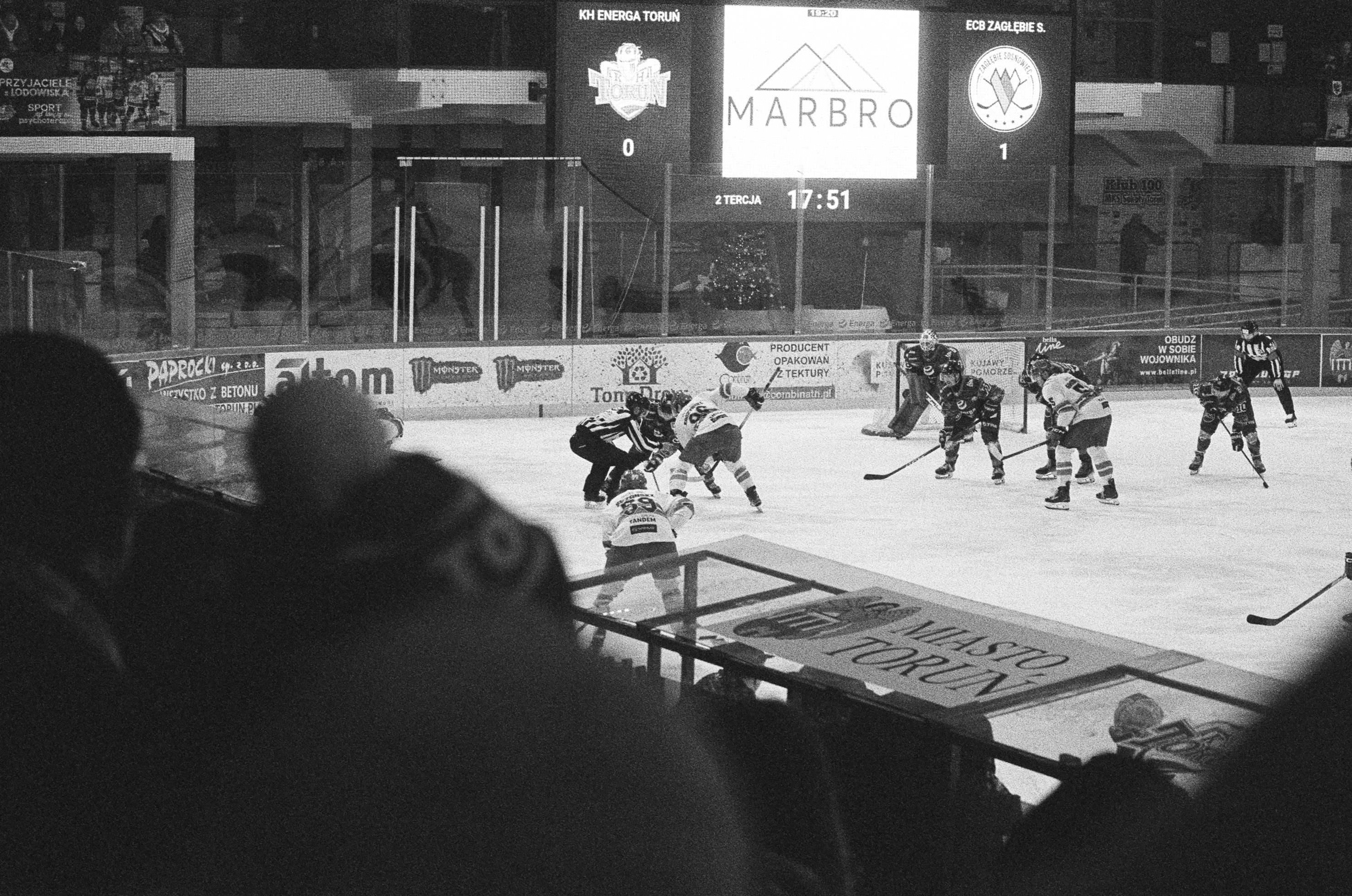 Ice hockey players compete on the rink during a game.