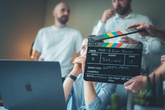 Filming a scene with a clapperboard and laptop