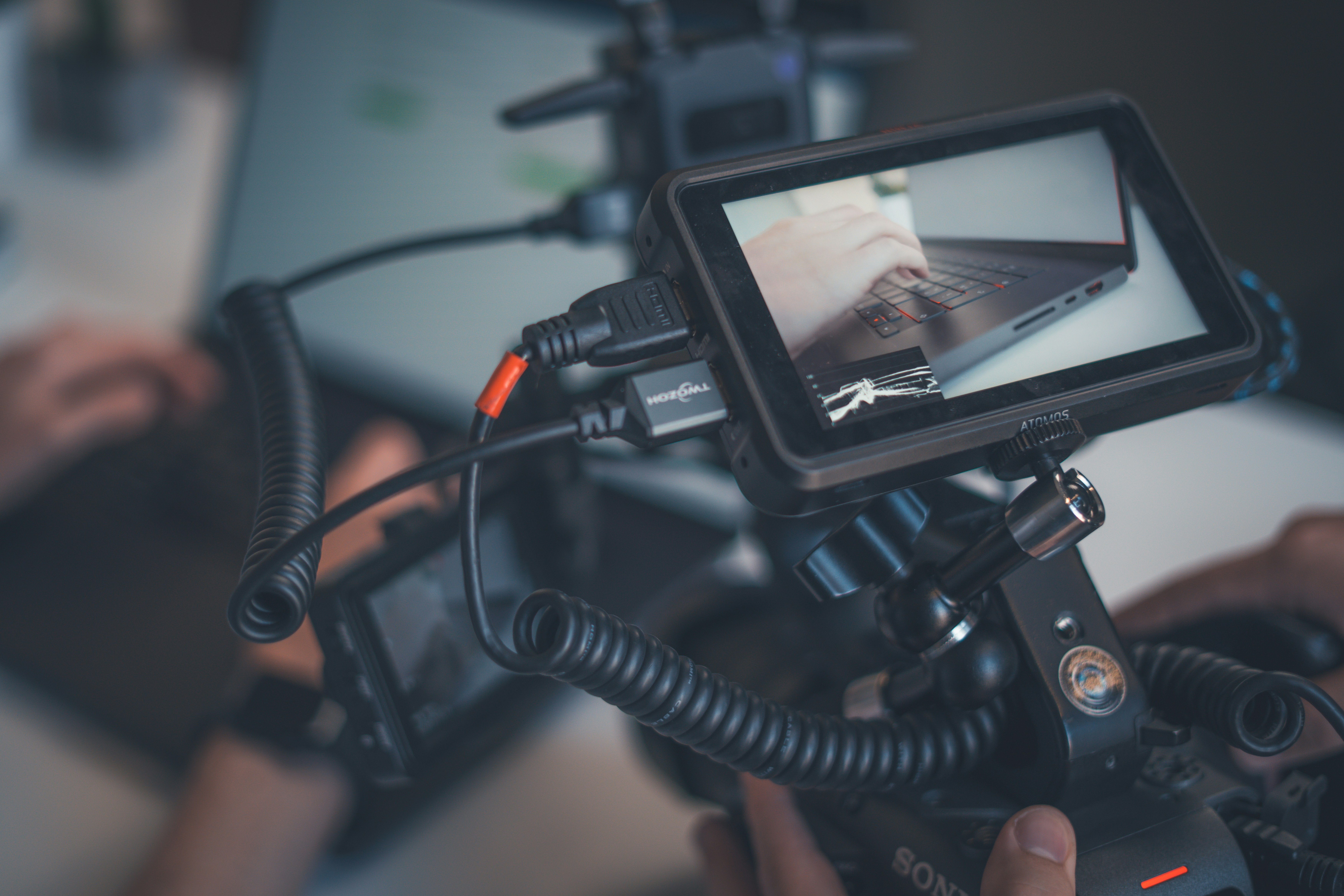 Camera monitor showing a laptop and cables