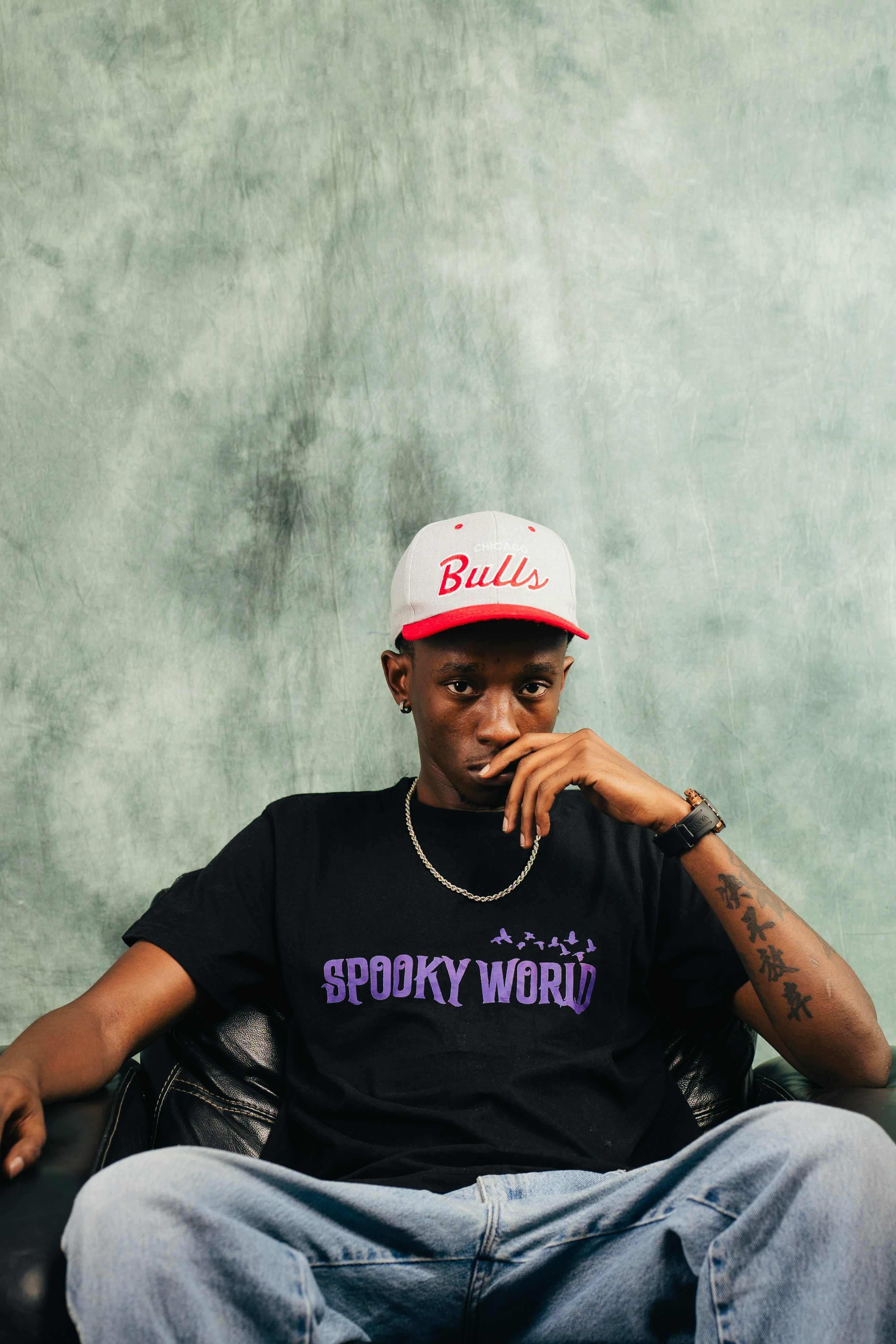Young man wearing a bulls hat and spooky world shirt
