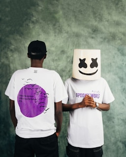 Two people with one wearing a marshmello helmet.