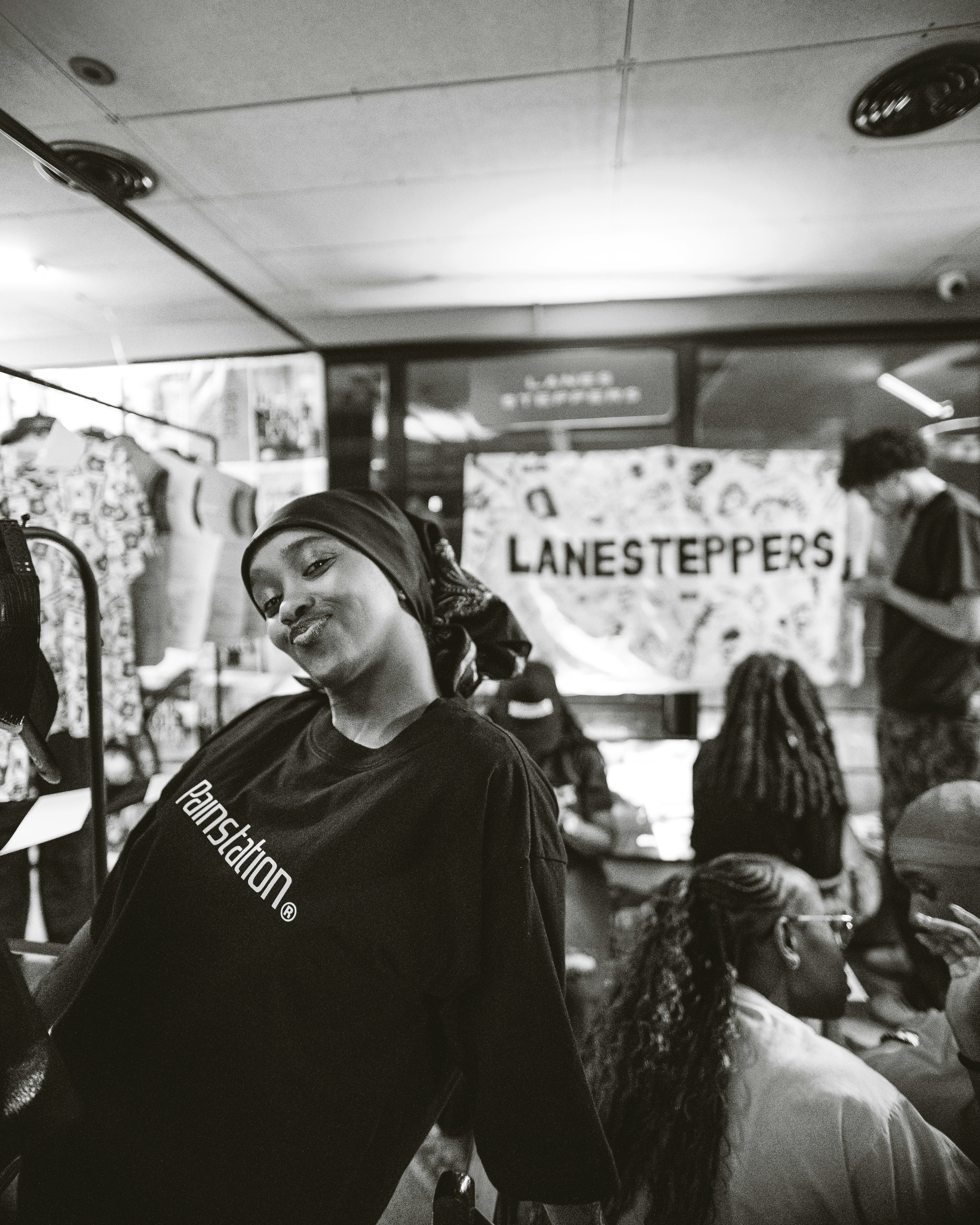 Young woman in a bandana and t-shirt smiles.