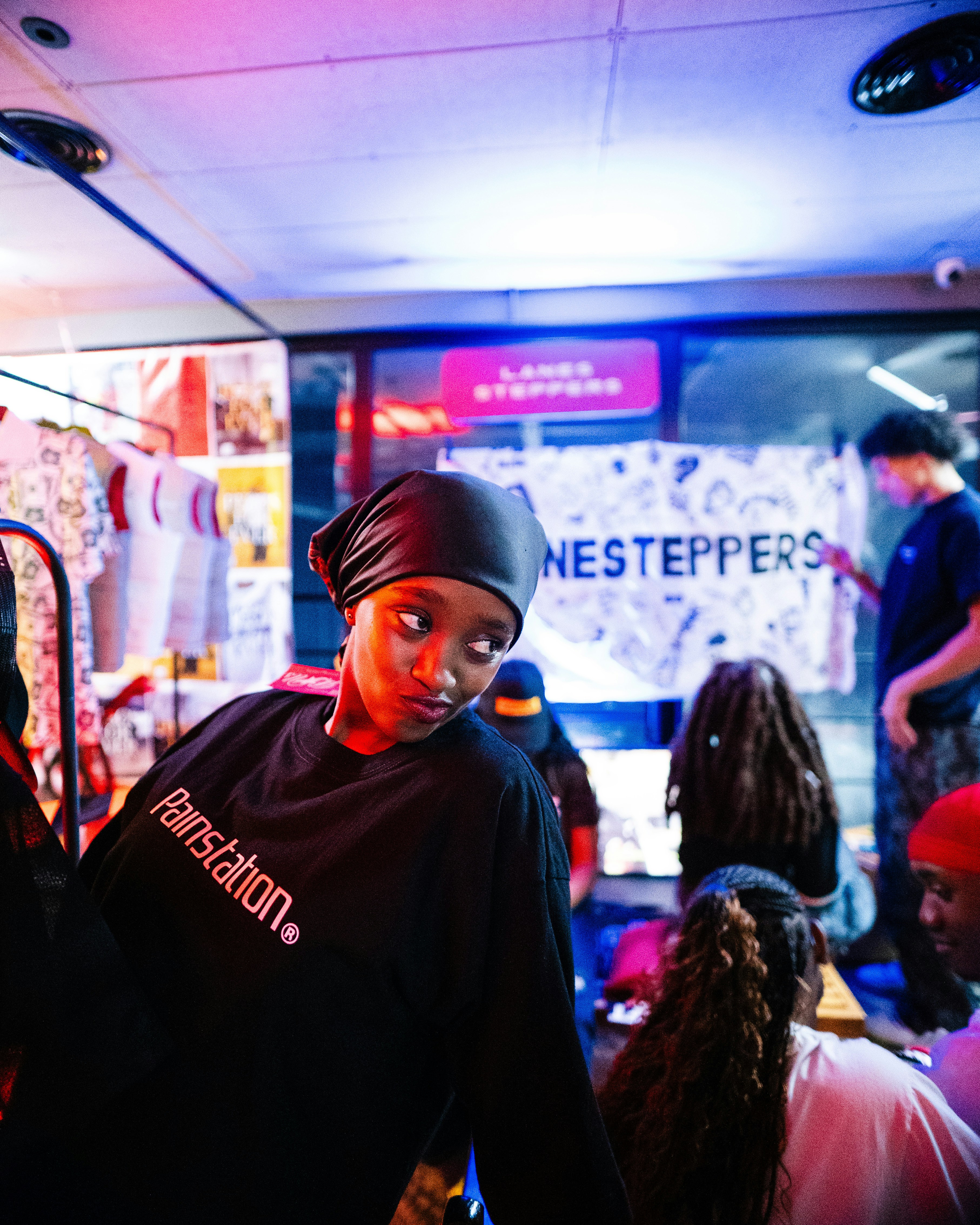 Young woman in black shirt with headscarf indoors