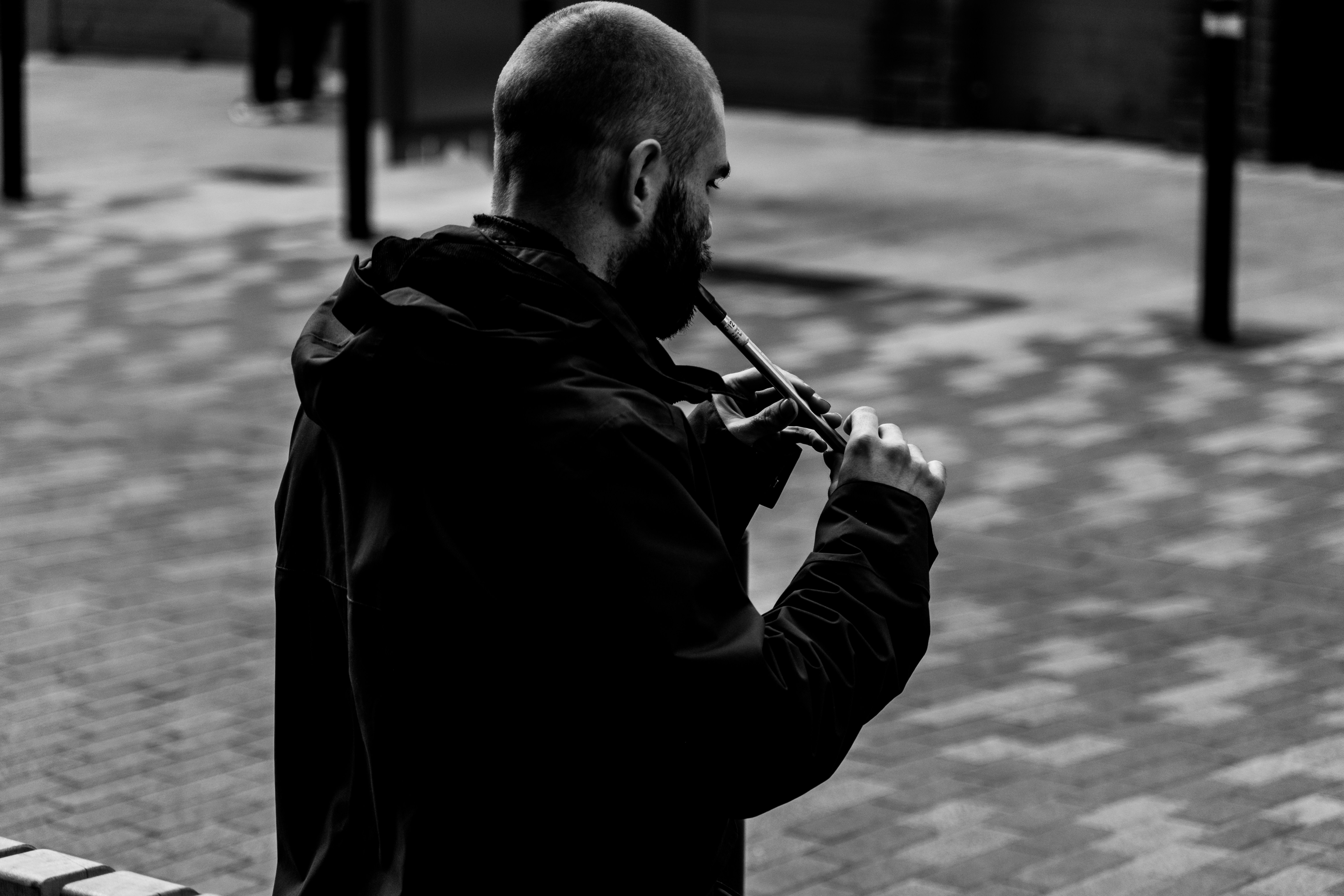 Man playing a wooden flute outdoors