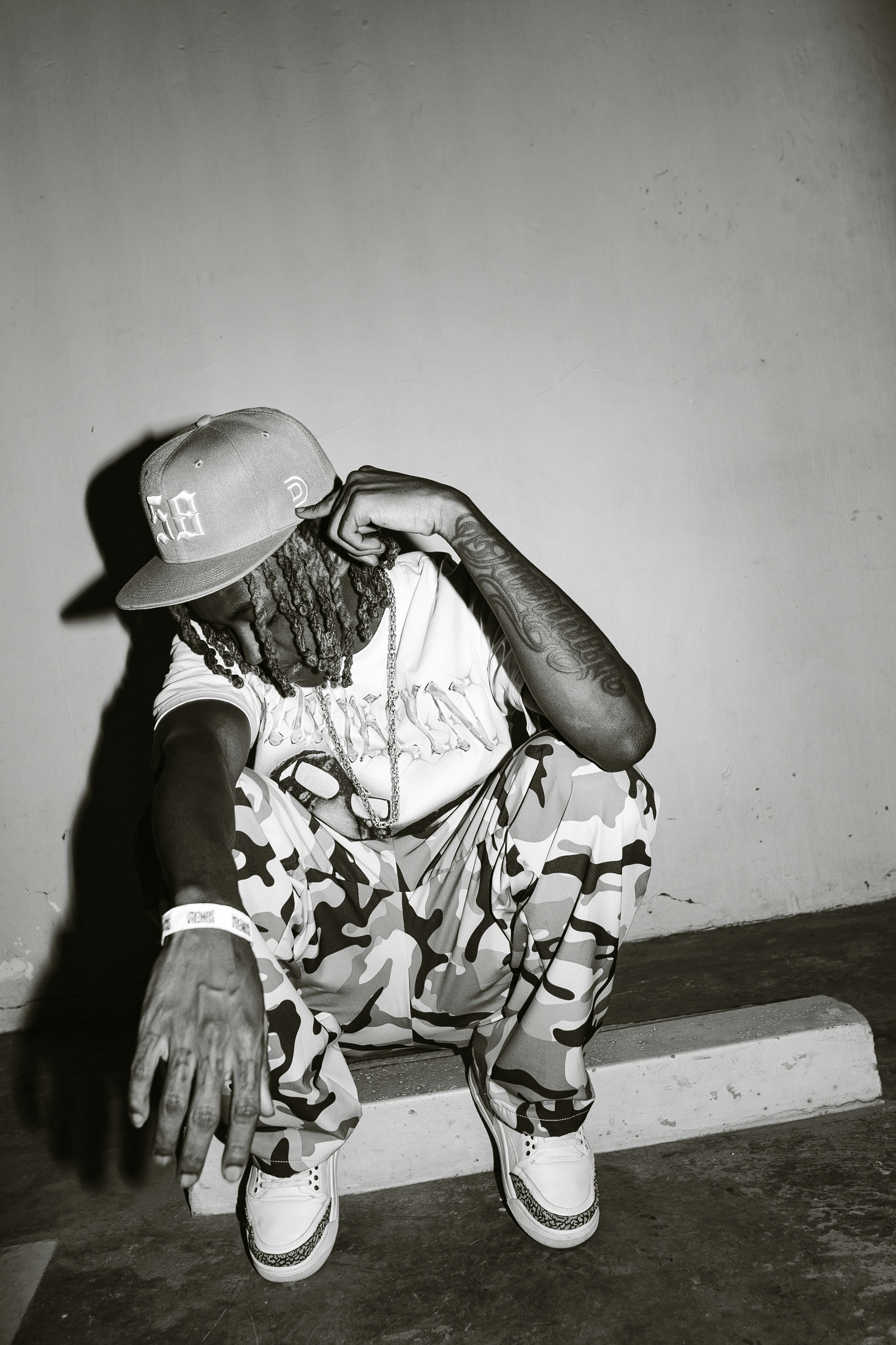 Man in camouflage pants and baseball cap