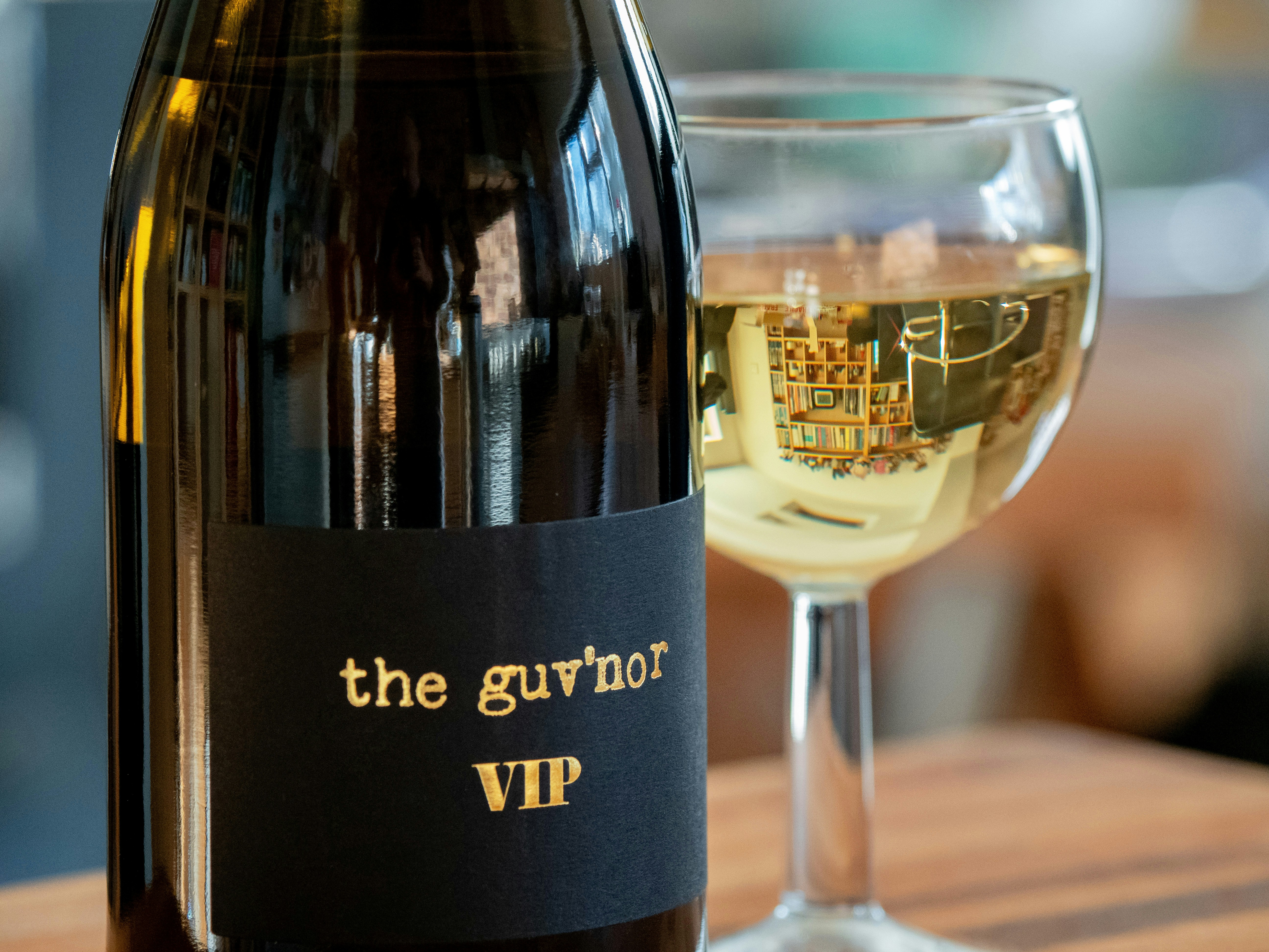 A bottle of wine and a glass of white wine.