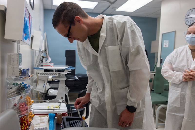 Scientist in lab coat examines sample in laboratory