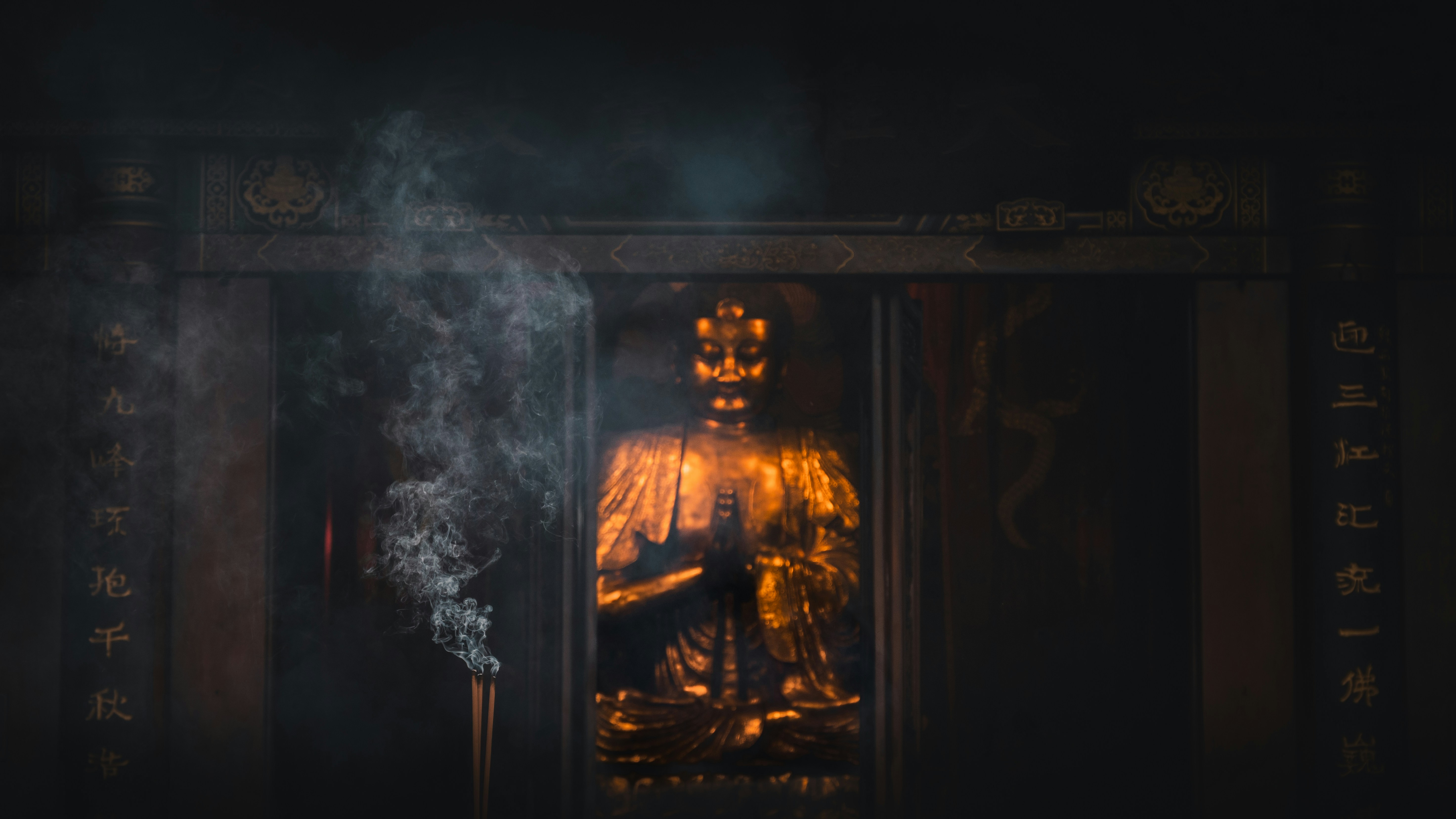 Golden statue with smoke in dark, ornate shrine