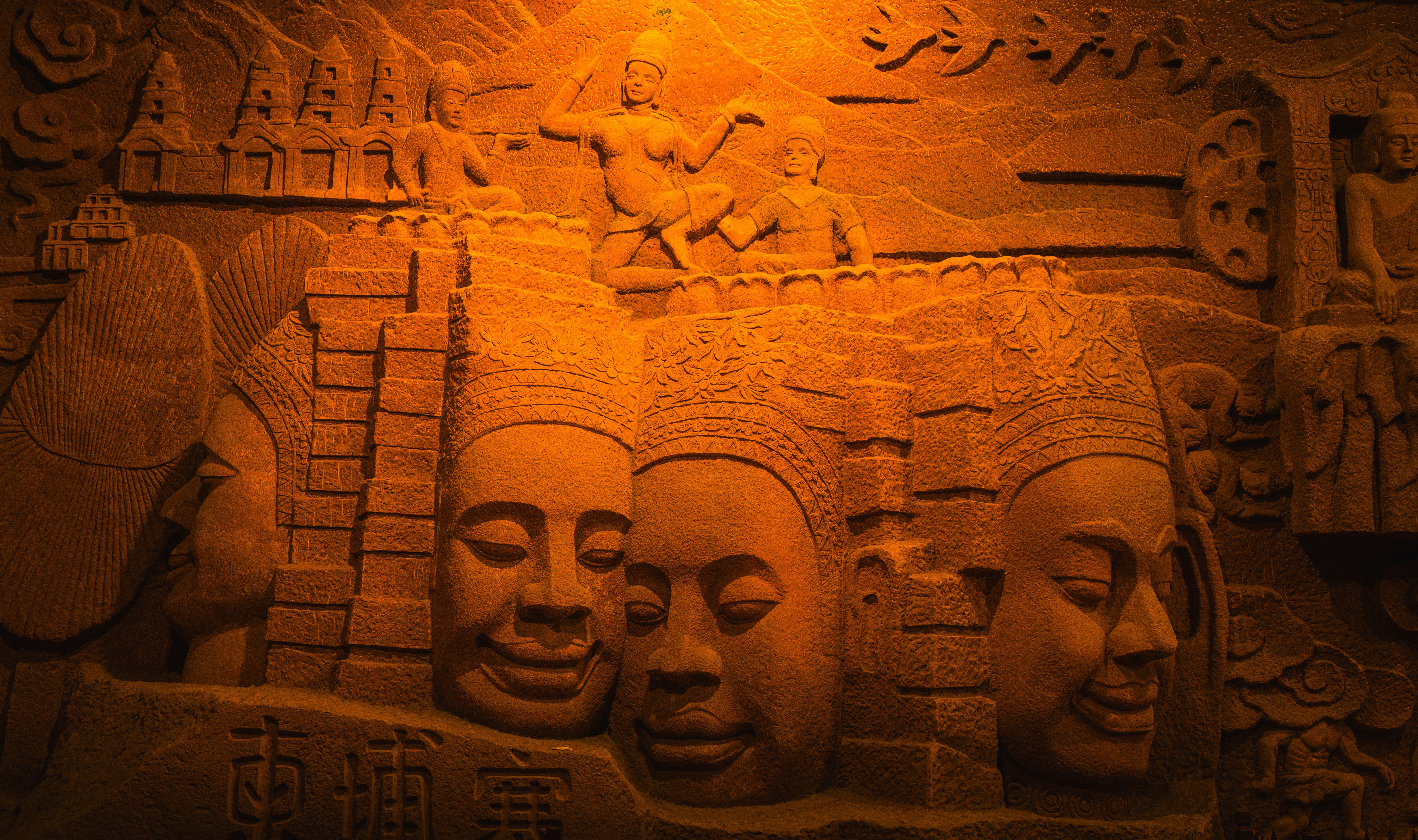 Intricate stone carving of faces and figures