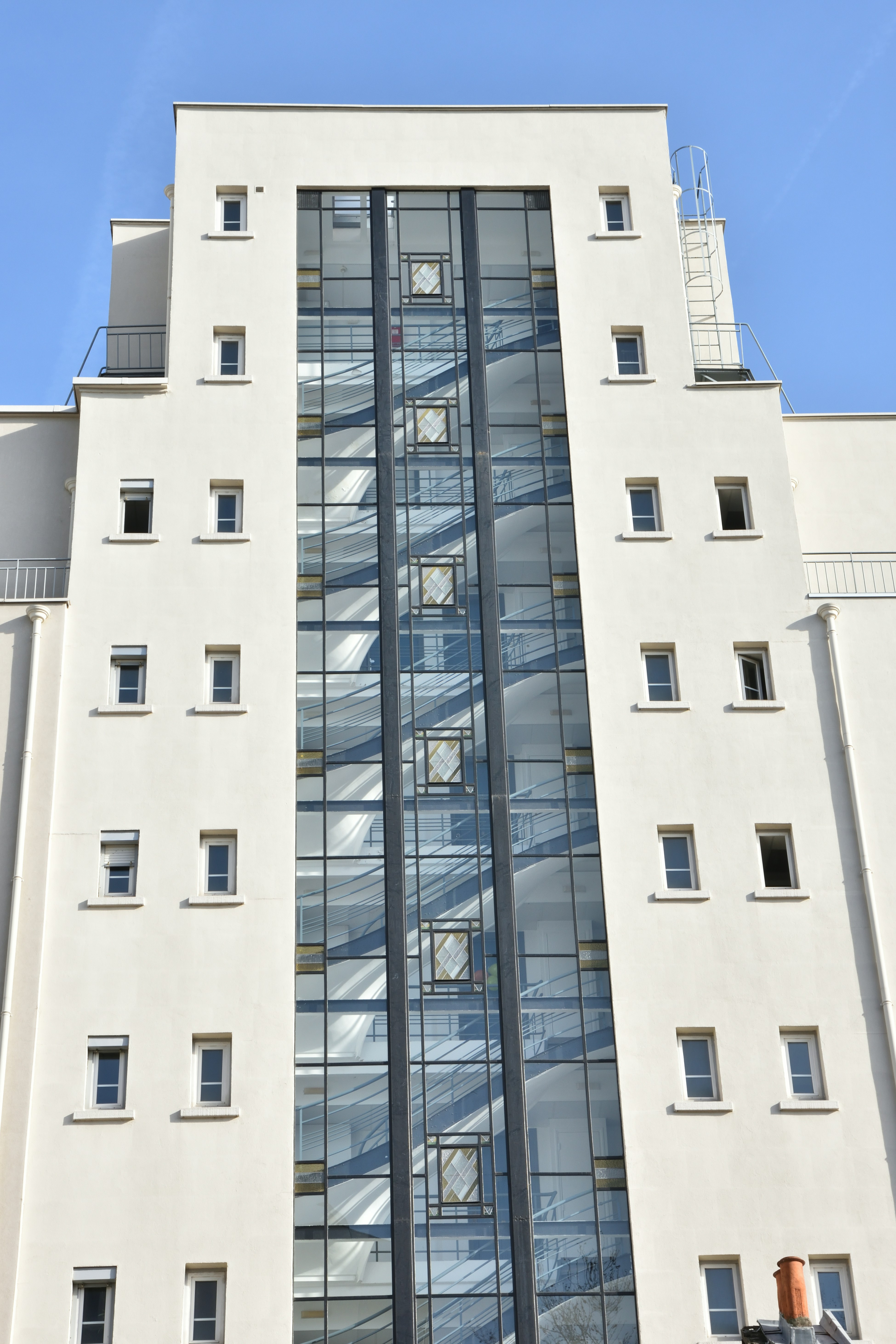 Modern building with glass elevator shaft and windows