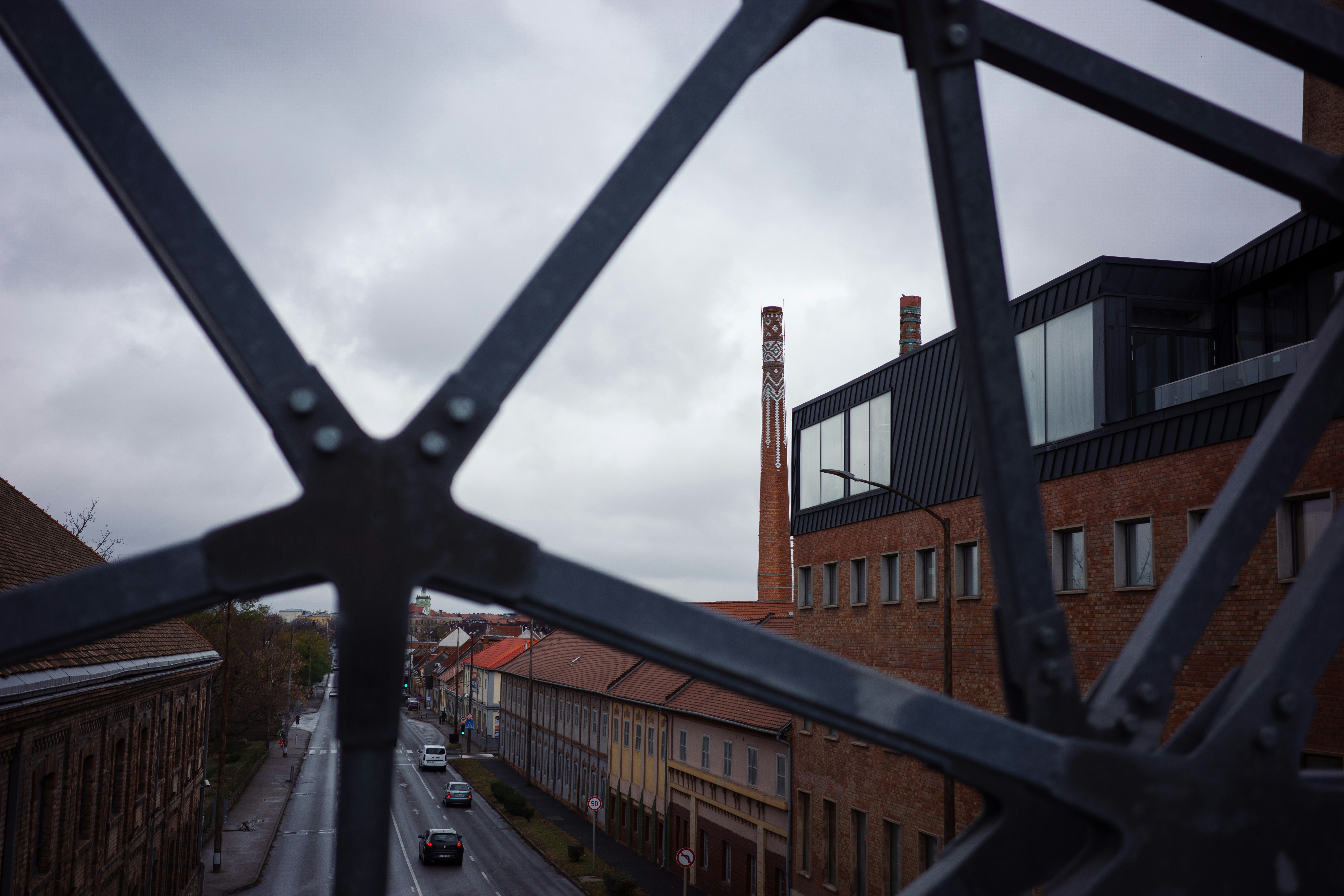 Industrial buildings with a smokestack under a cloudy sky
