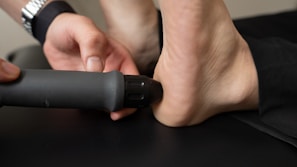 Close-up of a person receiving treatment on their heel.