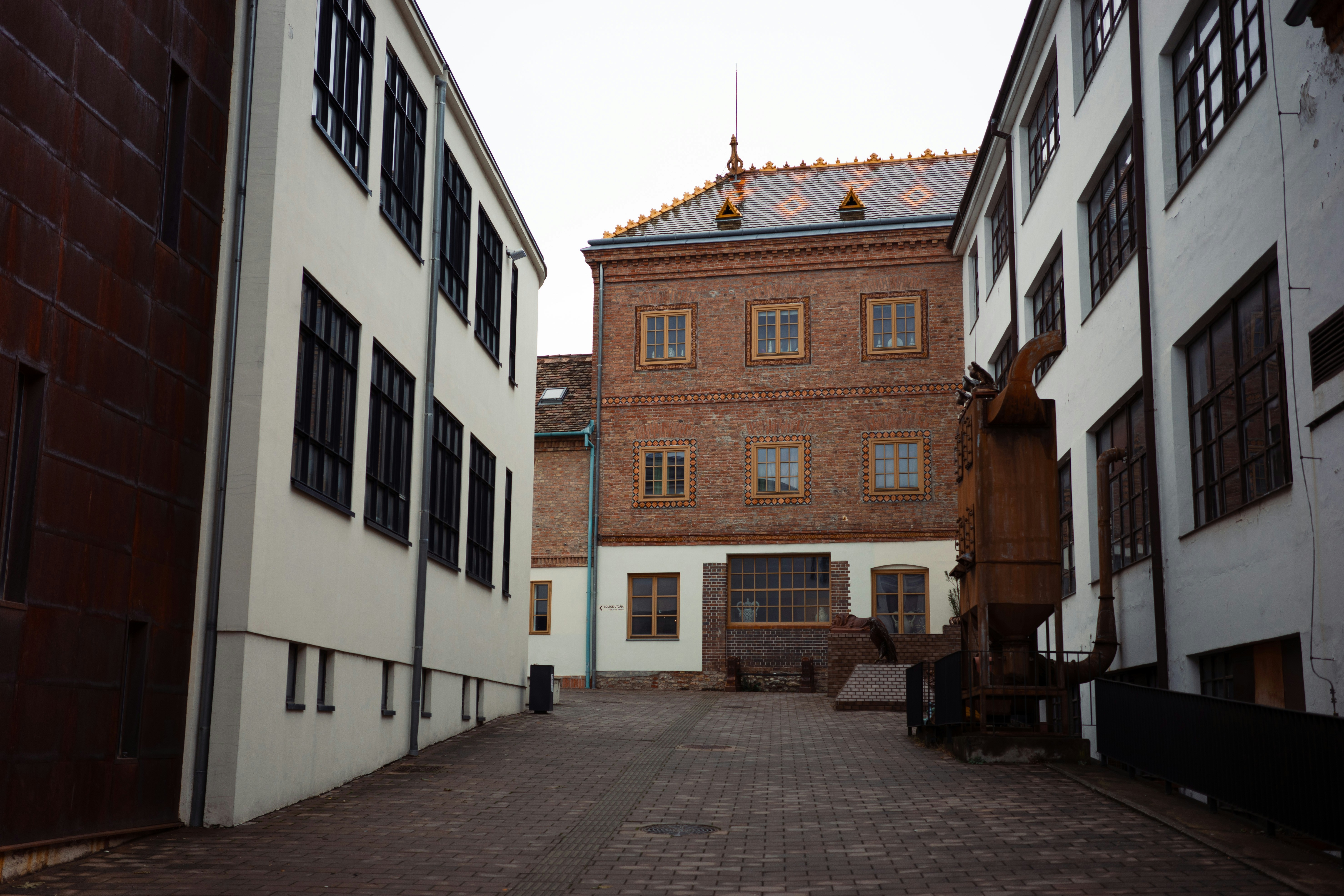 Courtyard between old brick and white buildings