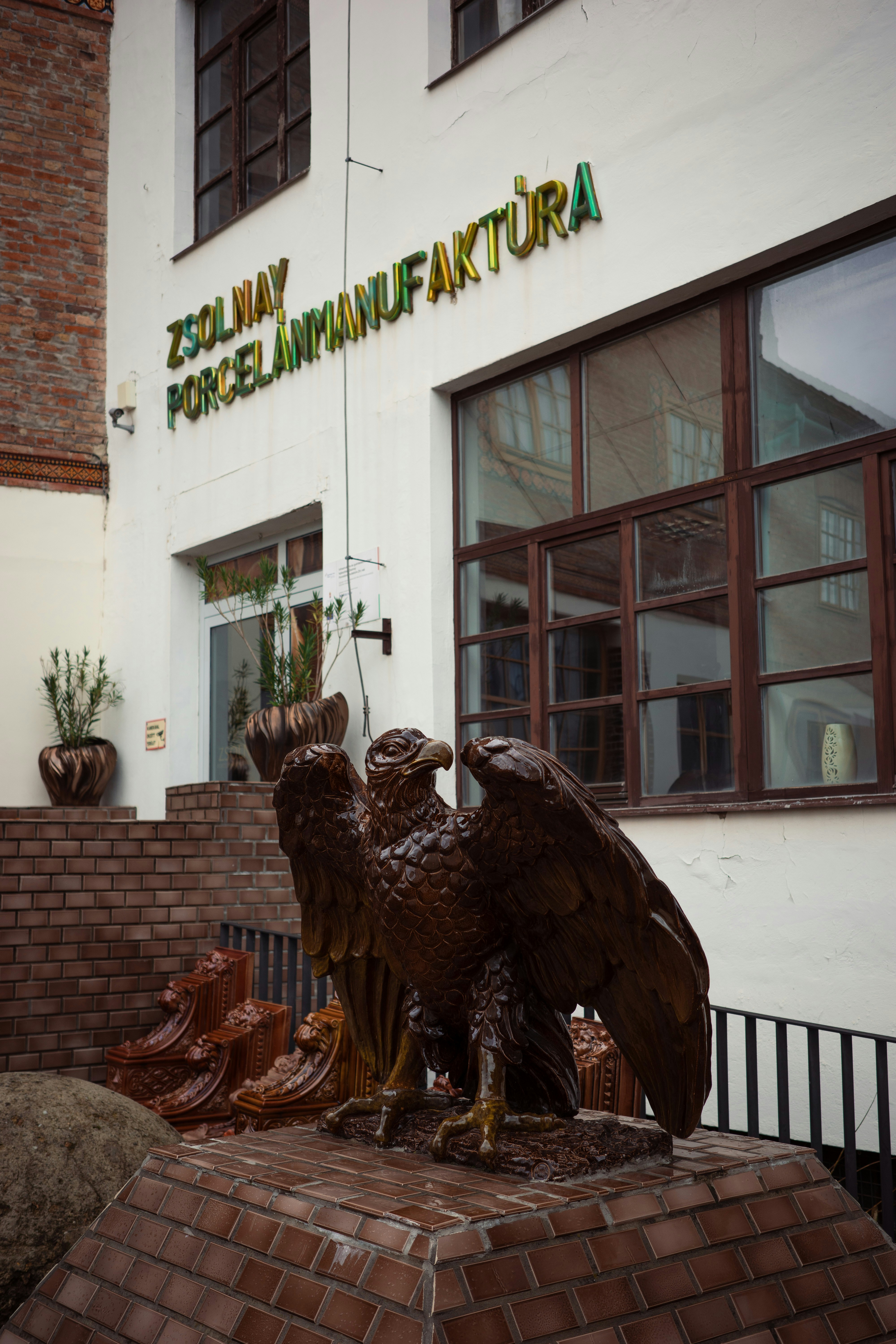 Bronze eagle statue outside zsolnay porcelain manufactory