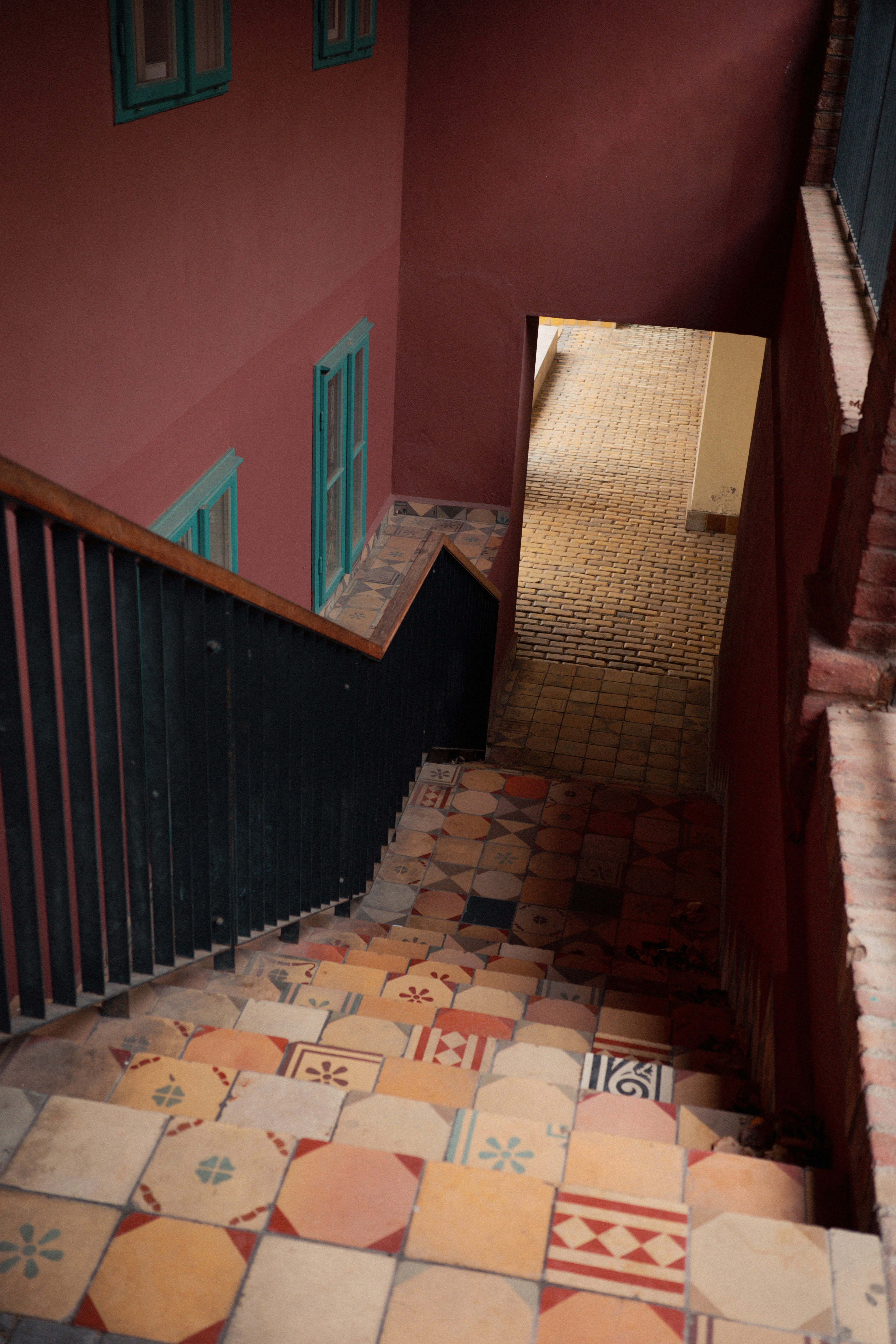 Colorful tiled staircase leading down to a hallway.