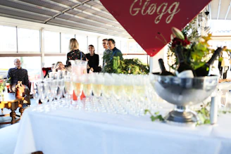 Champagne glasses and bottles on a table at an event.