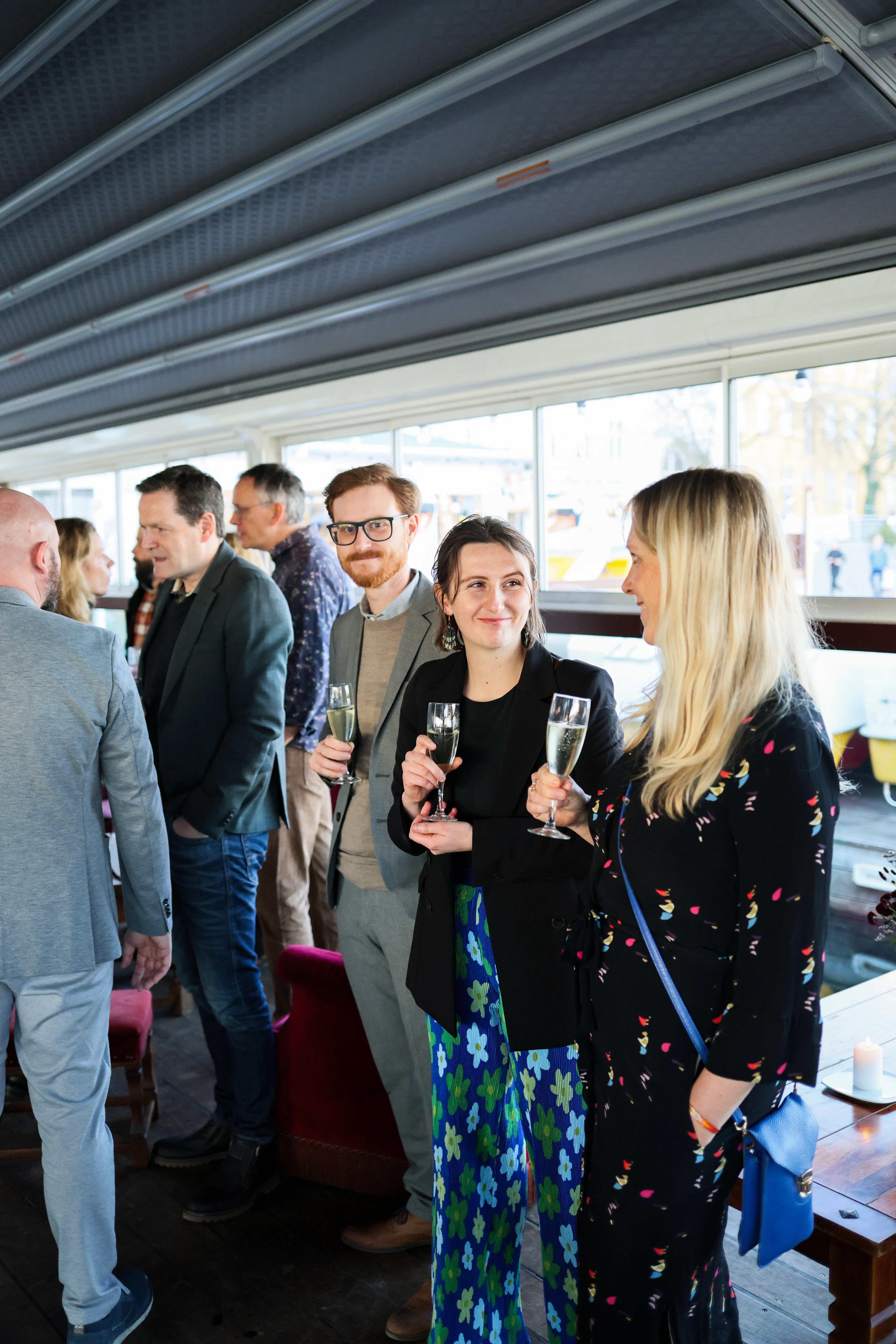 Guests raising champagne glasses at a social gathering