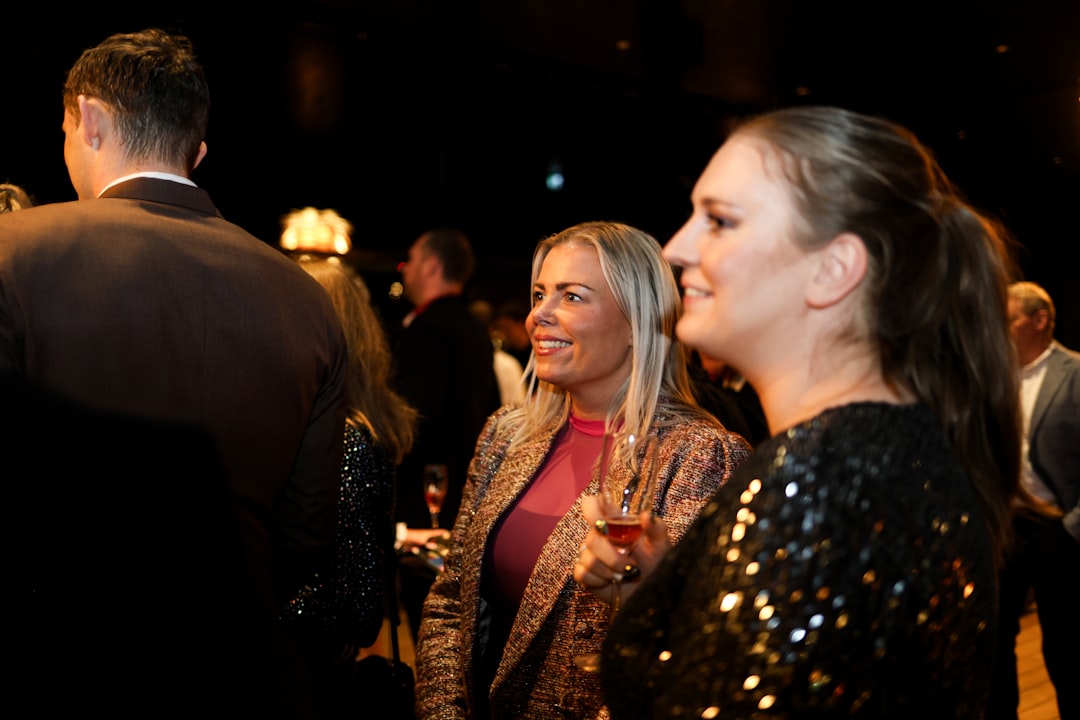 Two women smiling at a social gathering