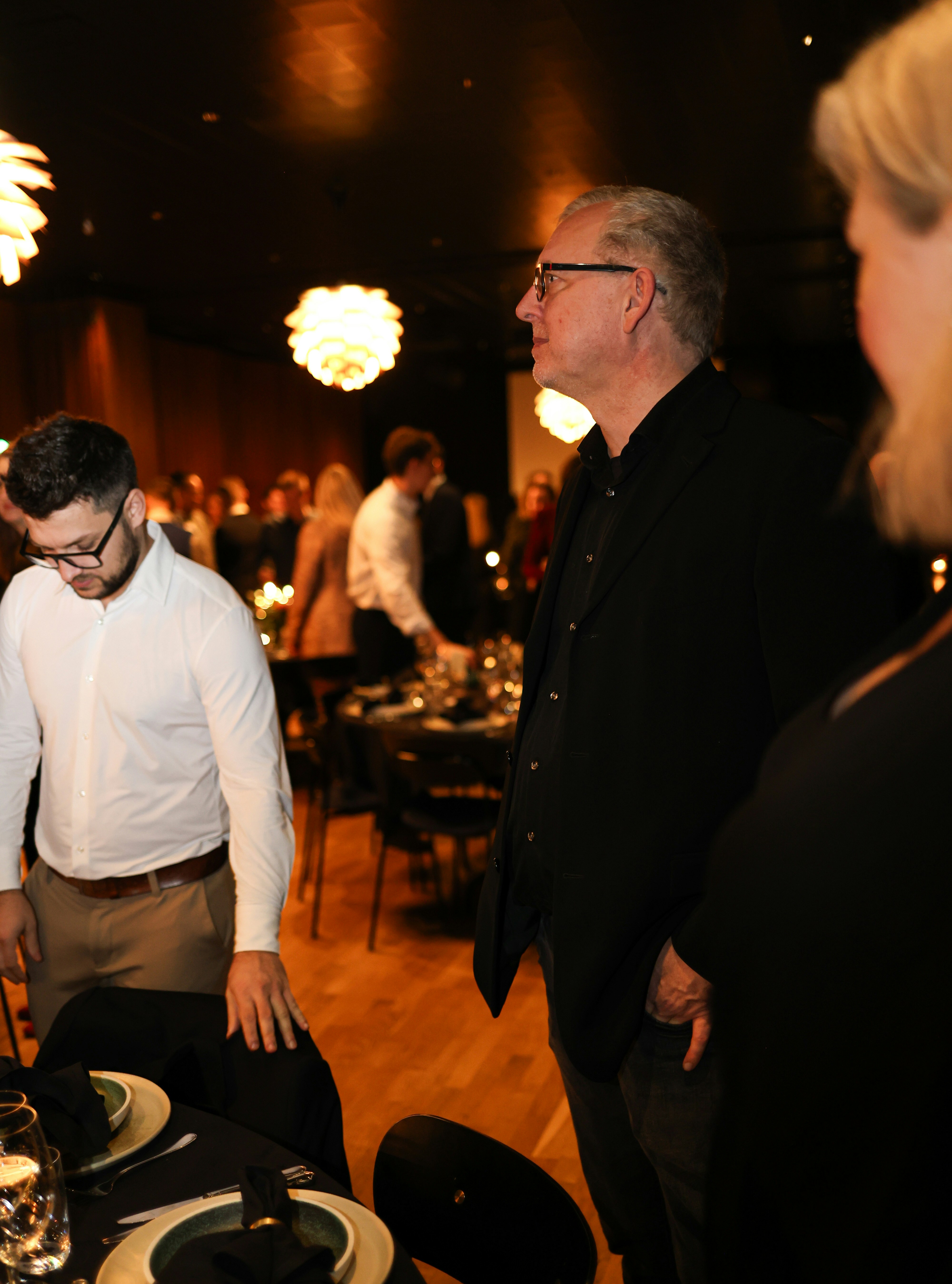 People gathered at a formal event with elegant decor.