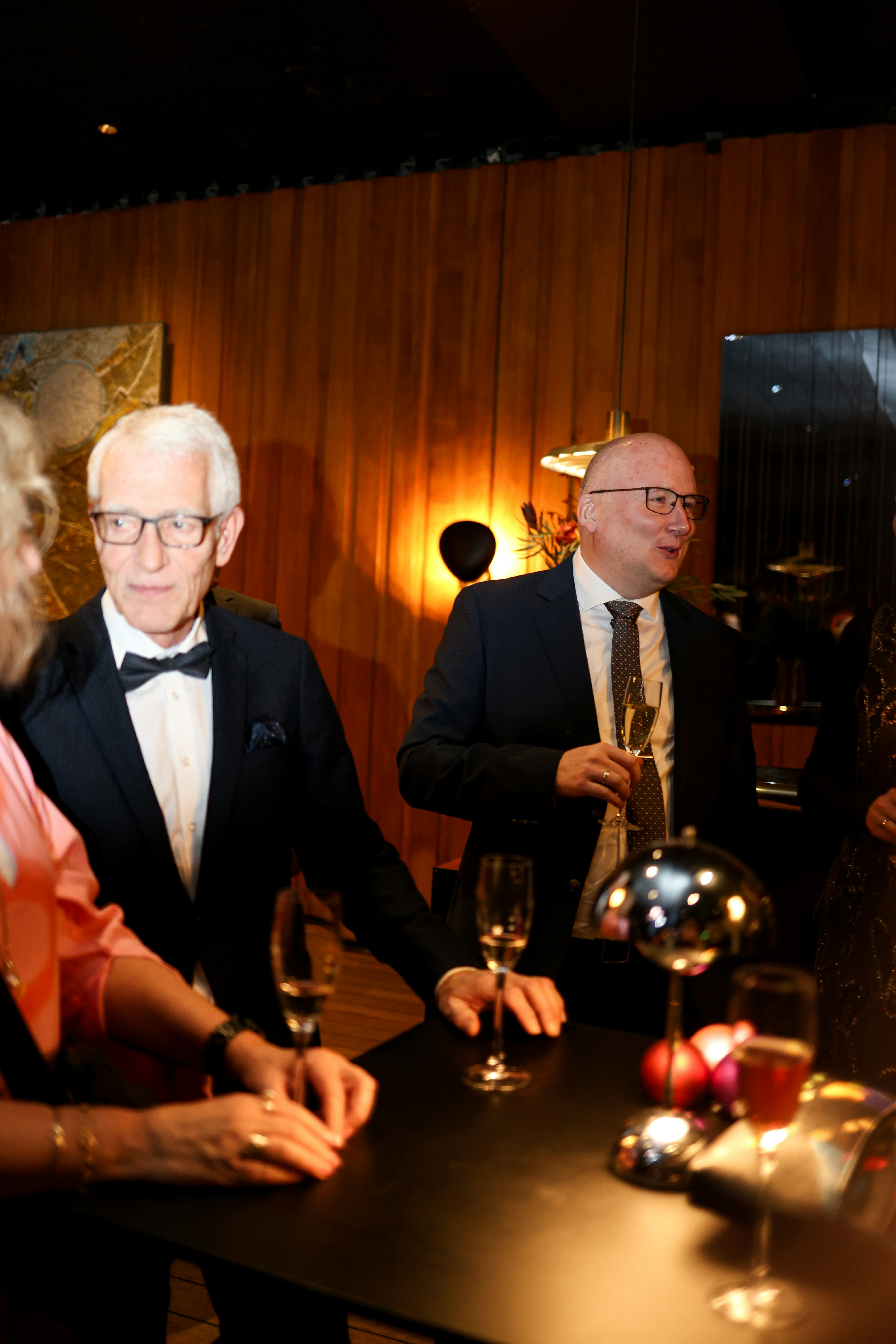 Two men in formal attire at a gathering.