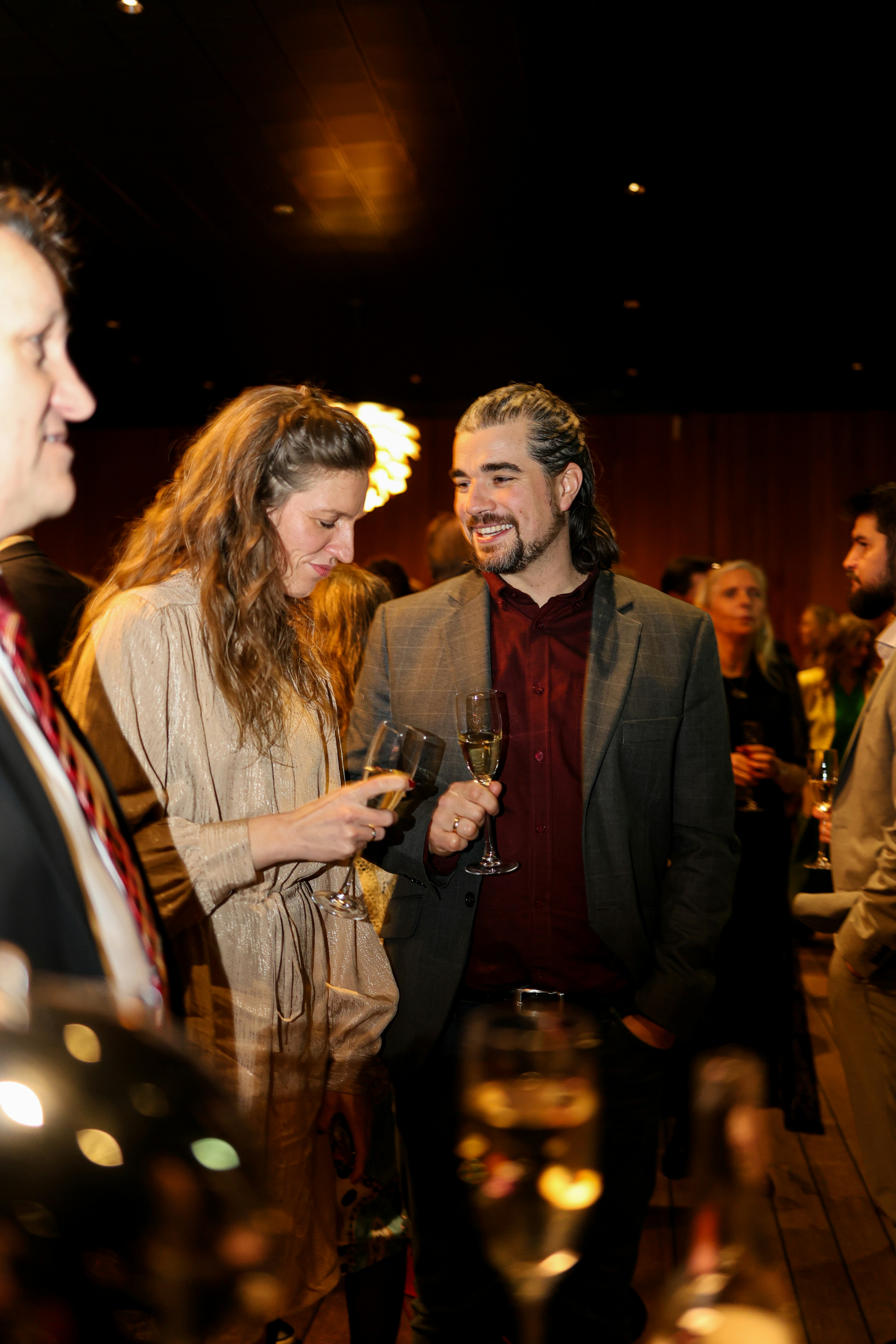 A man and woman holding champagne glasses