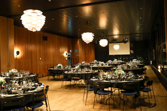 Elegant event space set with round tables for dining.