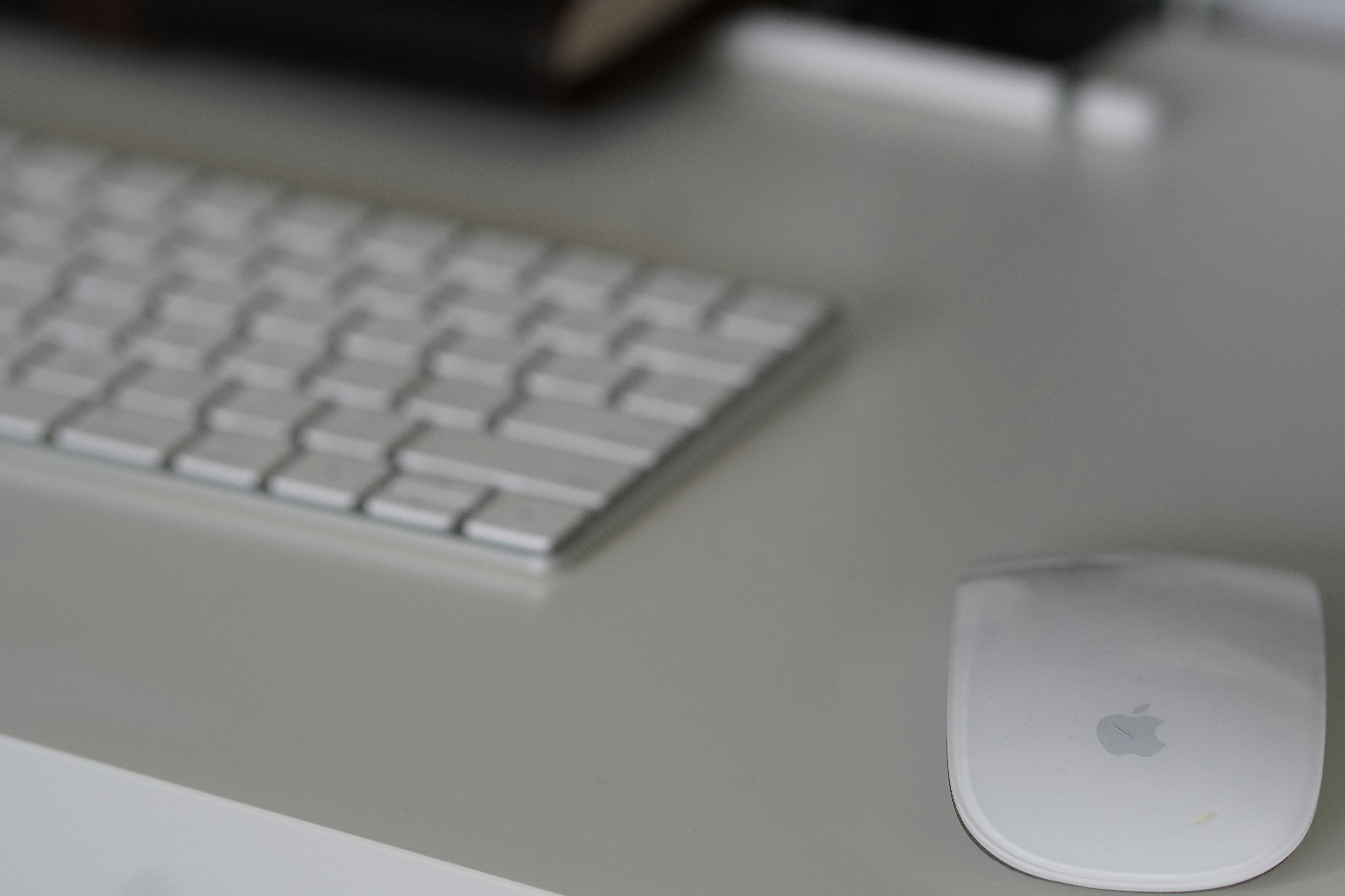 A white keyboard and mouse on a desk.