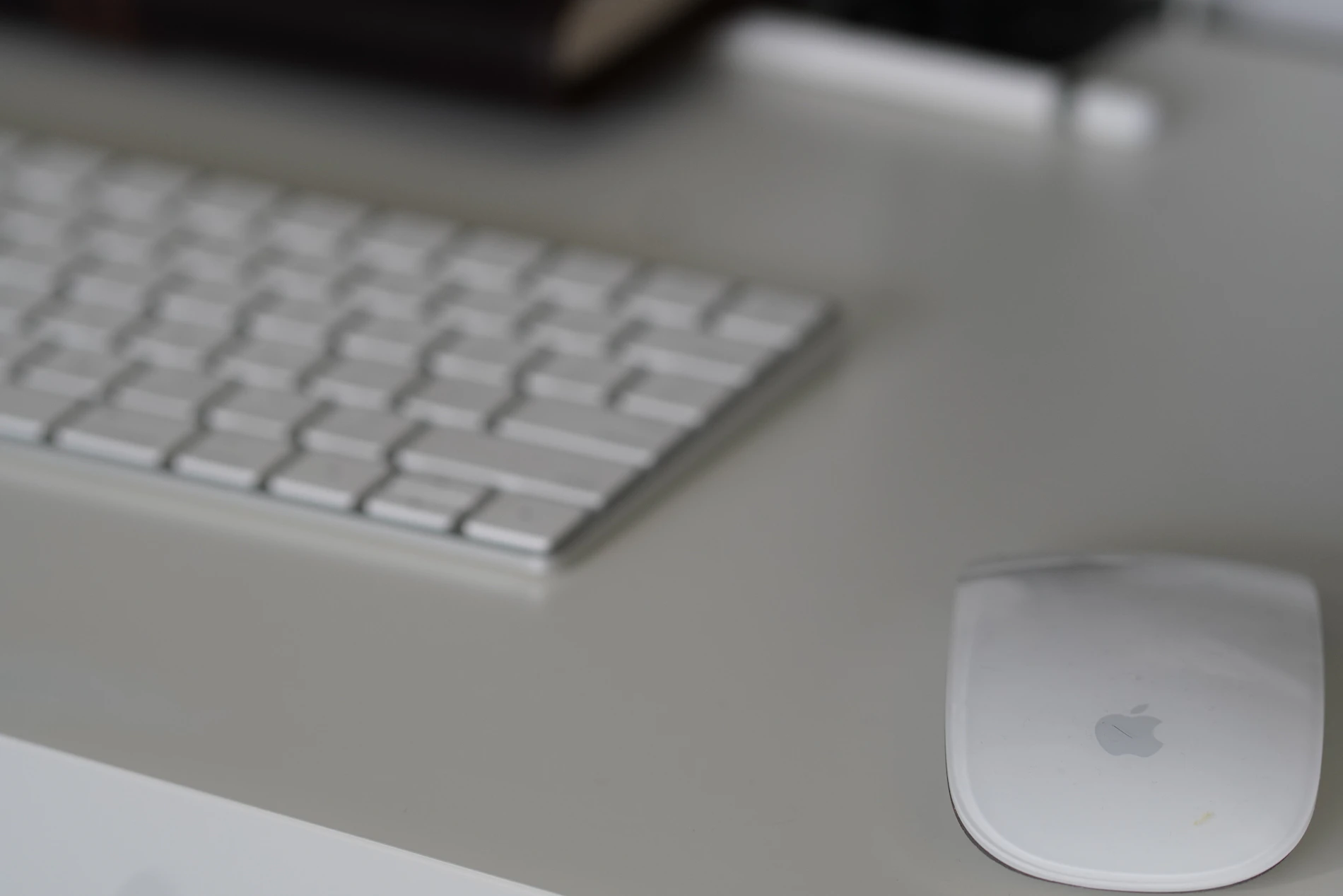 Keyboard mouse and desk accessories arranged in a clean professional workspace