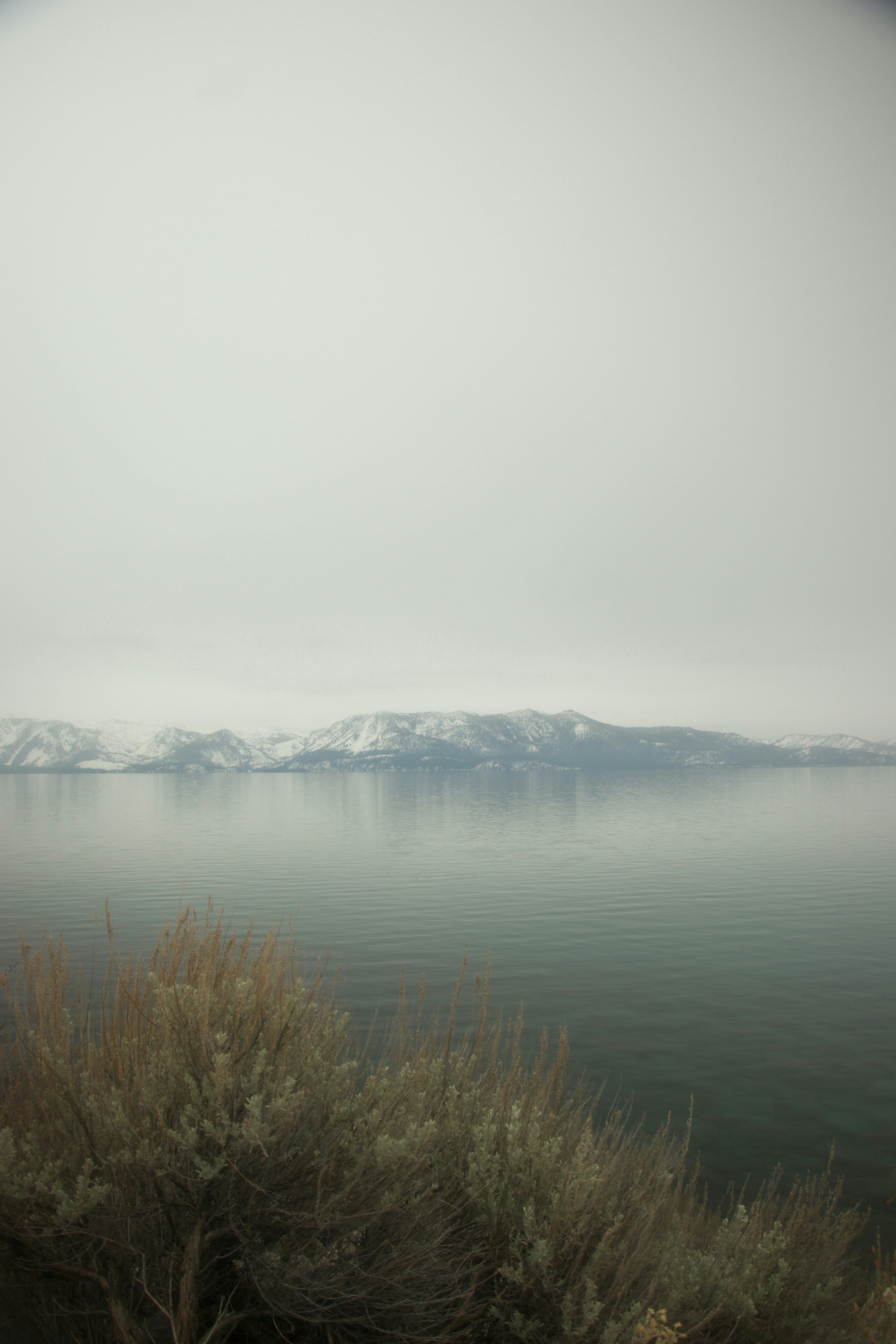 Snow-capped mountains reflected in a calm lake