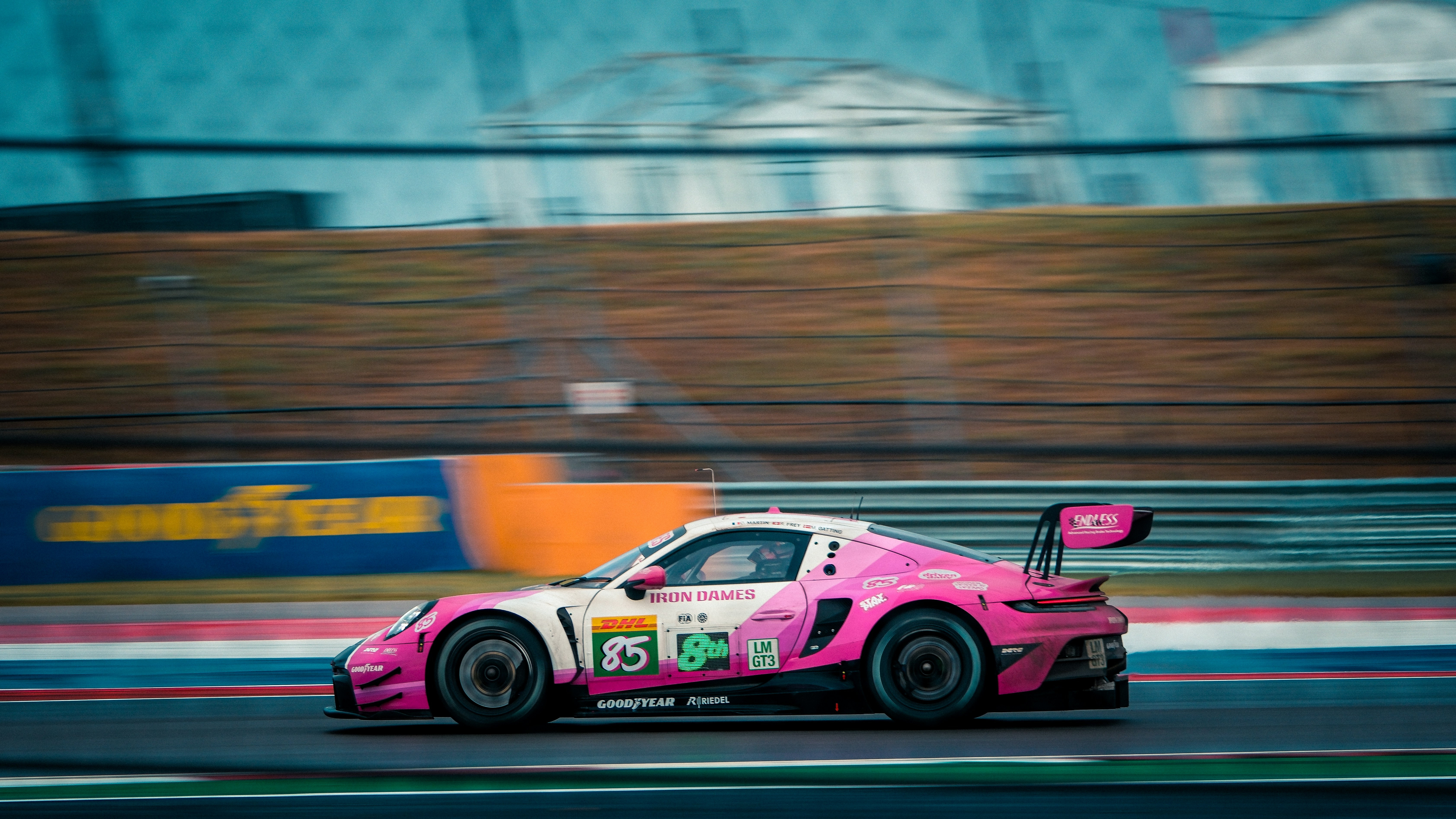 Pink race car speeding on a track