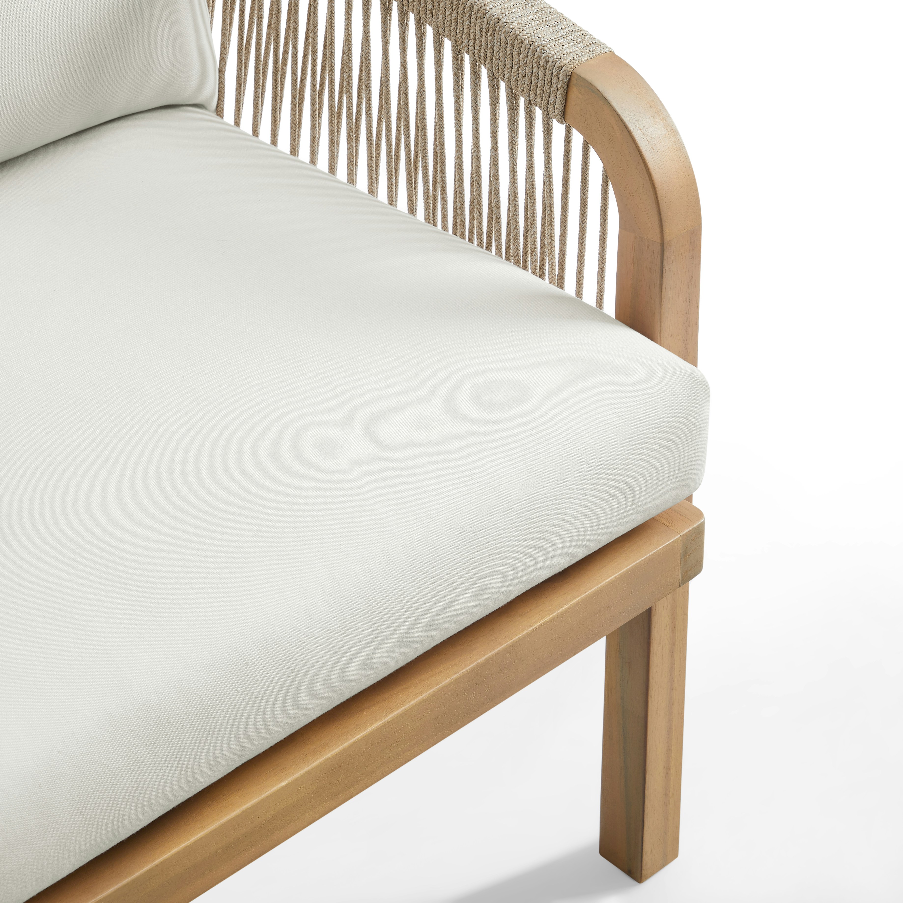 A modern outdoor chair with white cushions