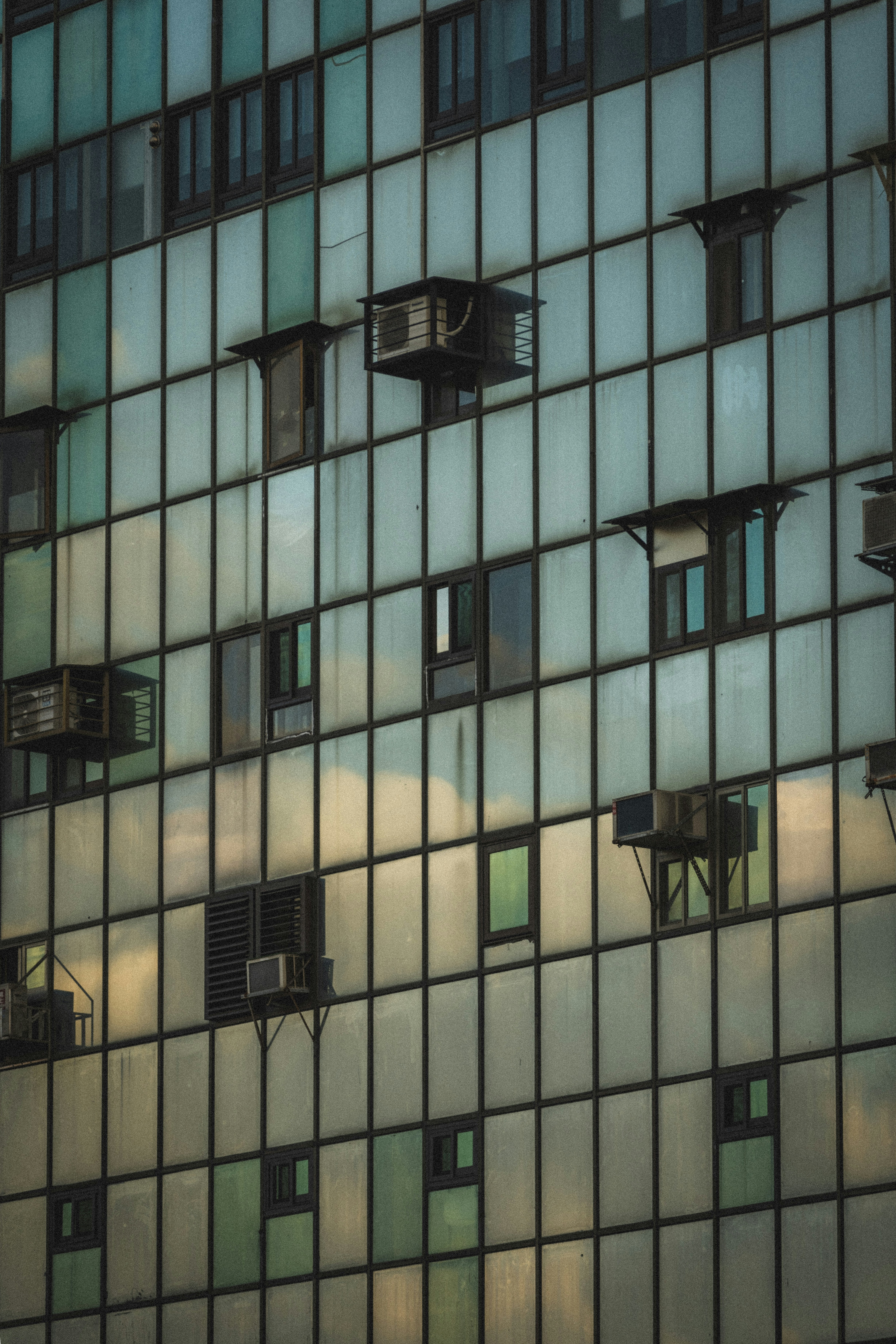 Modern building facade with many windows and air conditioners