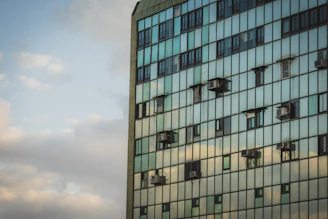 Modern glass building with windows and air conditioners