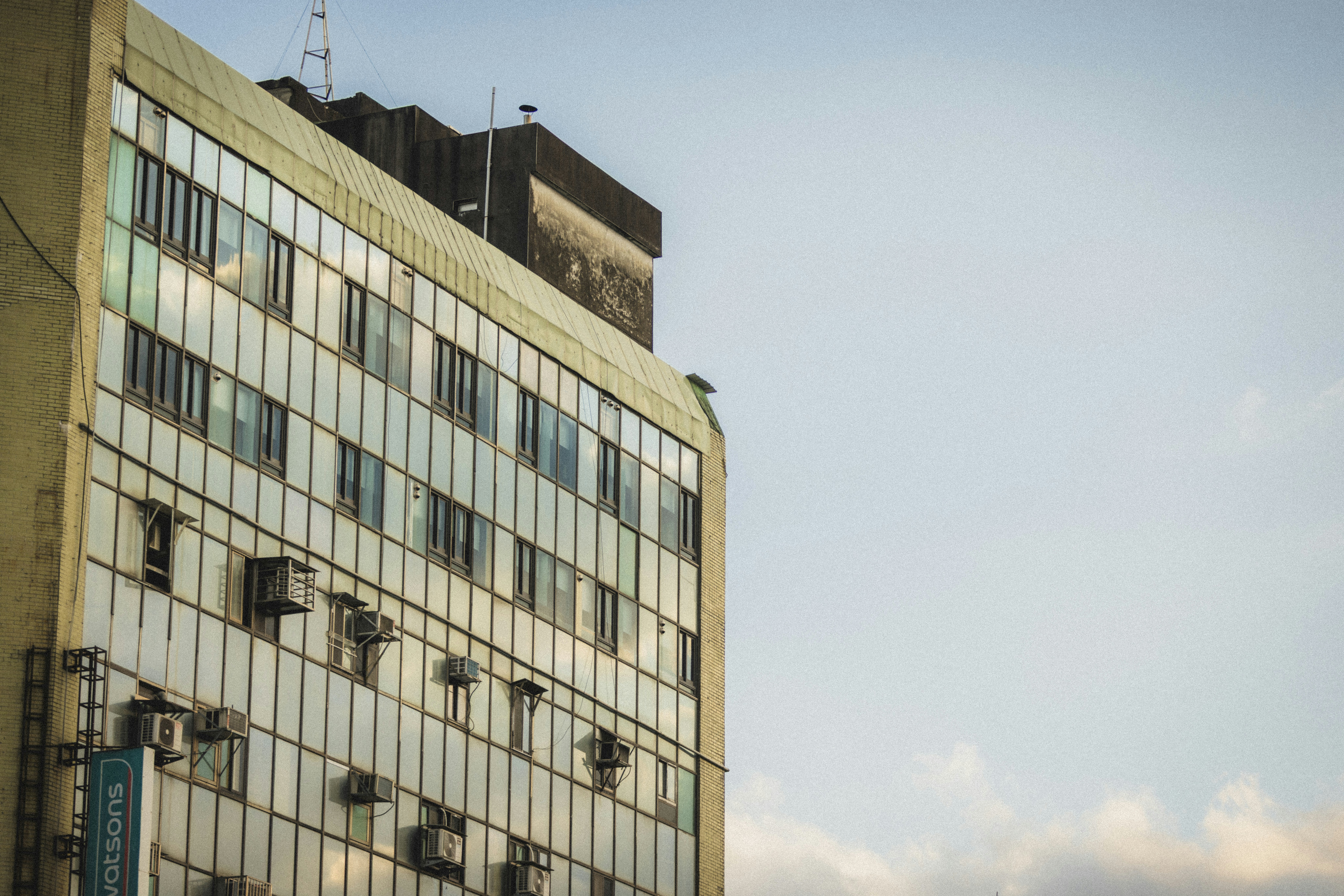 Modern building with reflective glass windows against sky