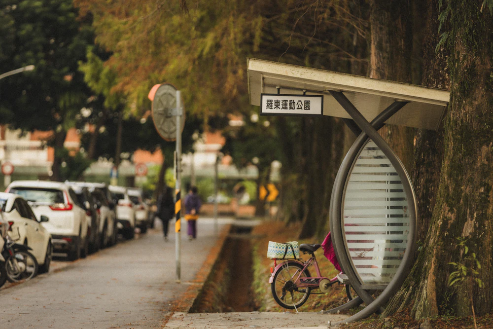 Neighborhood bus stop with bicycle and parked cars