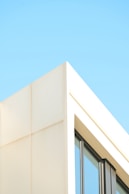 Modern building corner against a clear blue sky