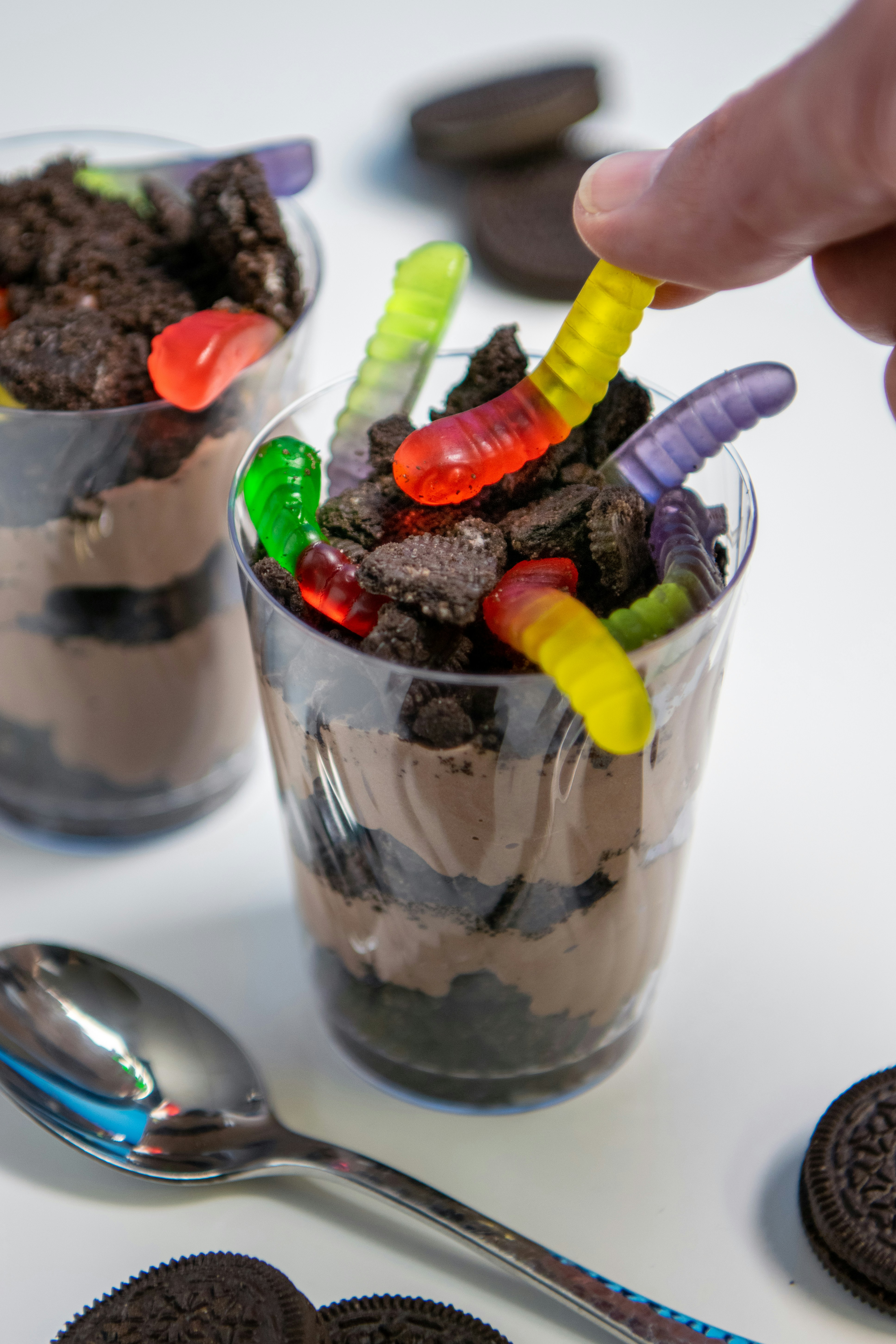 Chocolate dessert with gummy worms and crushed cookies